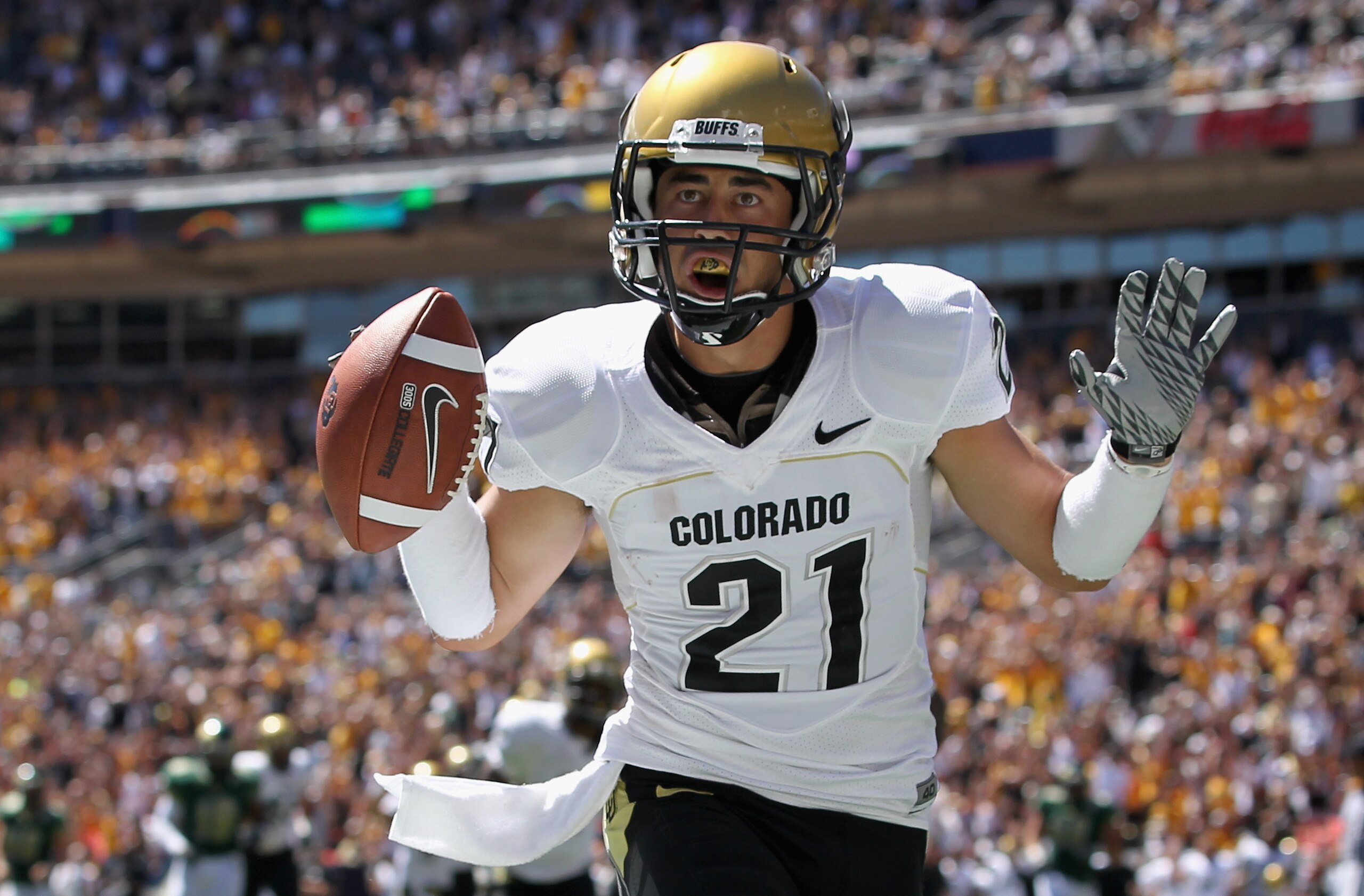 DENVER - SEPTEMBER 04:  Wide receiver Scotty McKnight #21 of the Colorado Buffaloes celebrates 27 yard touchdown reception to give the Buffs a 14-0 lead over the Colorado State Rams in the second quarter of the Rocky Mountain Showdown at INVESCO Field at 