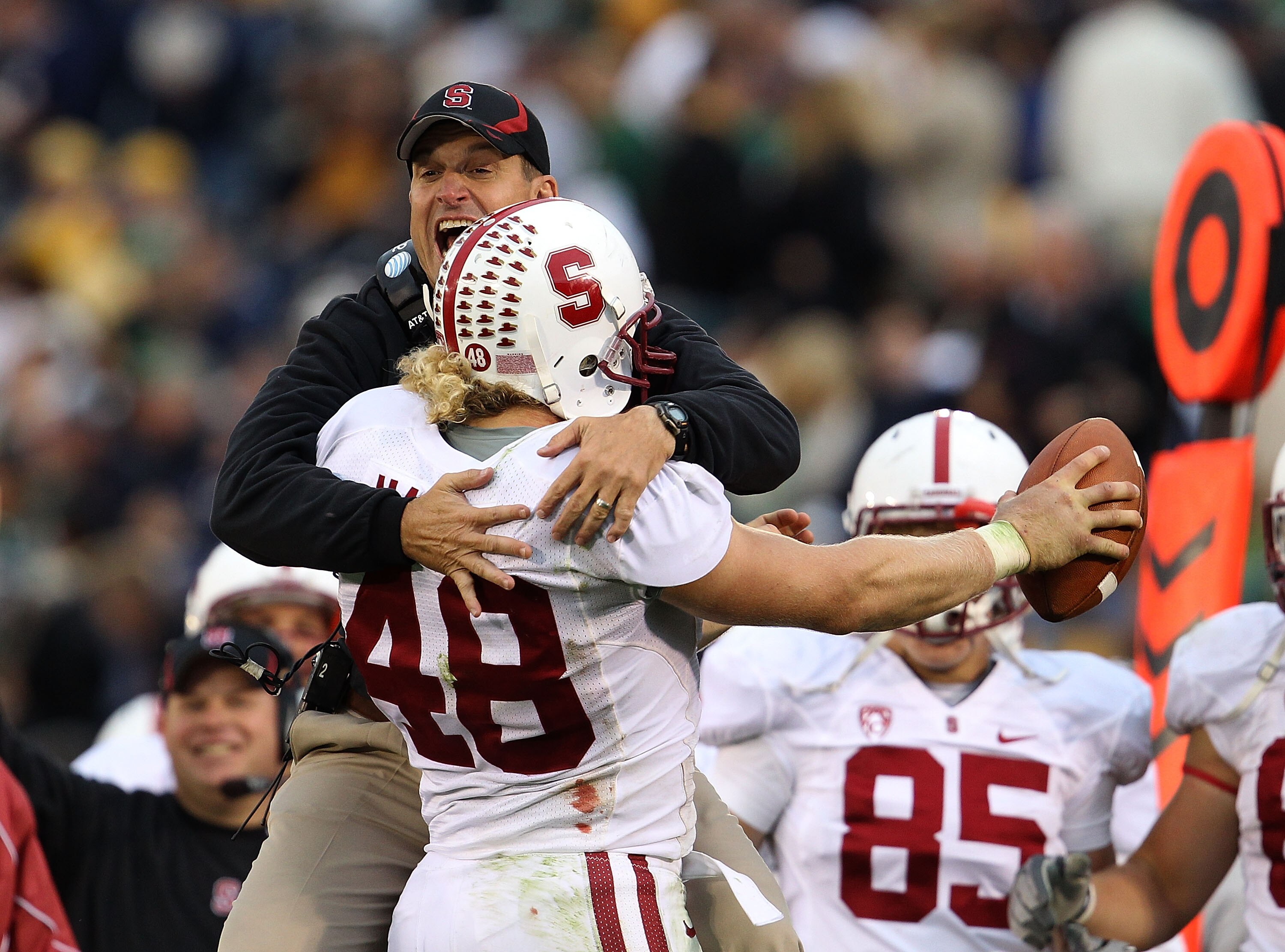 SOUTH BEND, IN - SEPTEMBER 25: Head coach Jim Harbaugh of the Stanford Cardinal jumps to greet Owen Marecic #48 after Marecic intercepted a pass for a touchdown against the Notre Dame Fighting Irish at Notre Dame Stadium on September 25, 2010 in South Ben