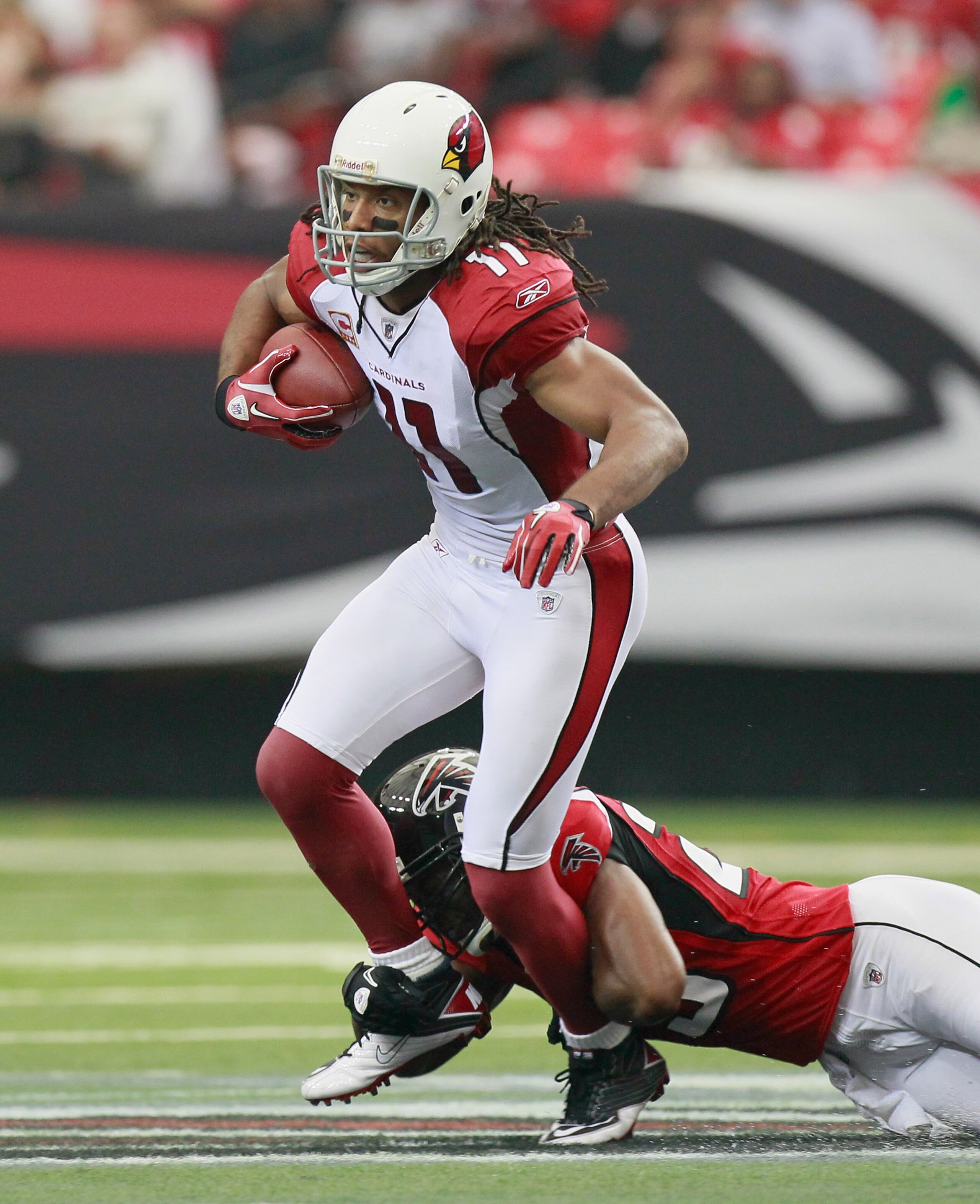 ATLANTA - SEPTEMBER 19:  Larry Fitzgerald #11 of the Arizona Cardinals is tackled by Brian Williams #29 of the Atlanta Falcons at Georgia Dome on September 19, 2010 in Atlanta, Georgia.  (Photo by Kevin C. Cox/Getty Images)