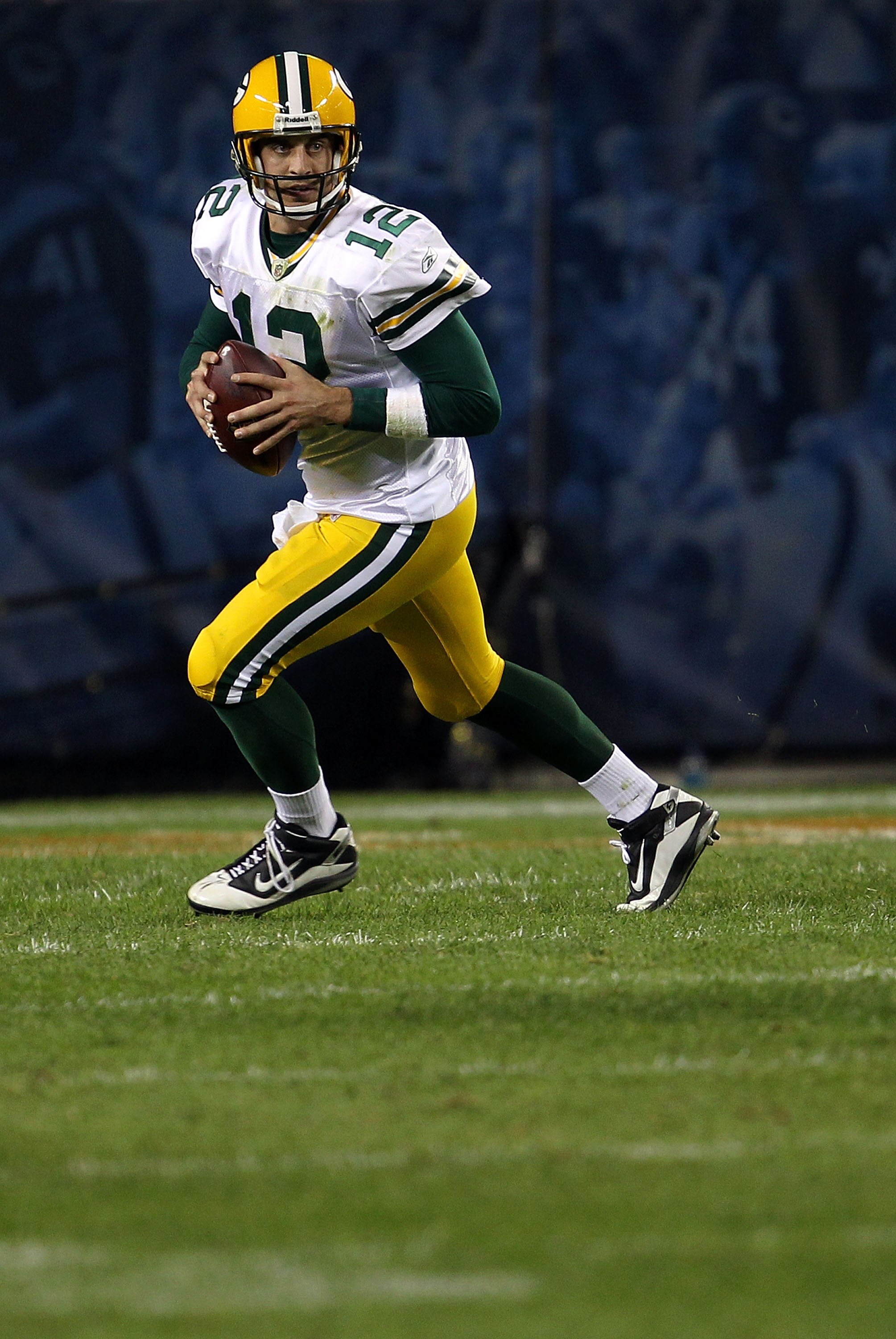 CHICAGO - SEPTEMBER 27:  Aaron Rodgers #12 of the Green Bay Packers rolls out to pass against the Chicago Bears at Soldier Field on September 27, 2010 in Chicago, Illinois. The Bears won 20-17.  (Photo by Jonathan Daniel/Getty Images)