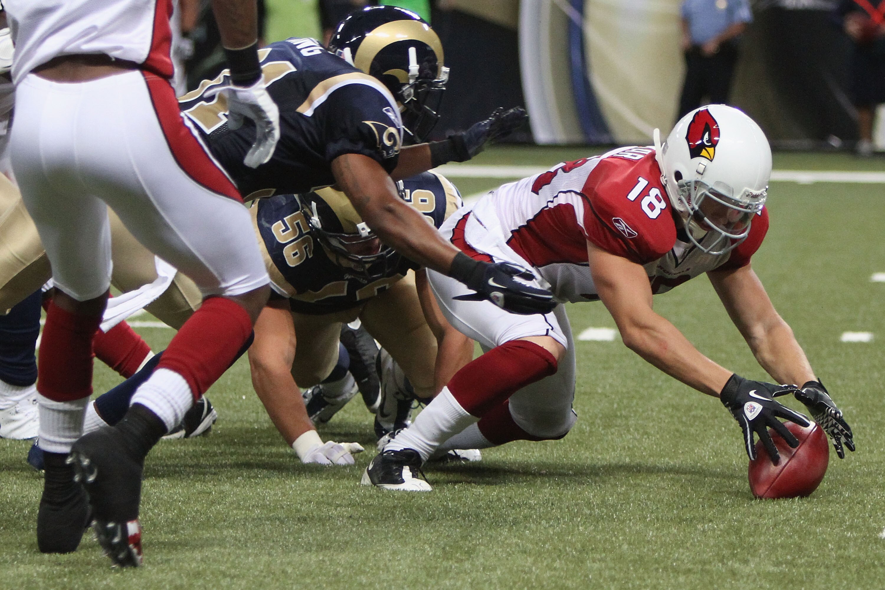 ST. LOUIS - SEPTEMBER 12: Max Komar #18 of the Arizona Cardinals recovers his own fumble against the St. Louis Rams during the NFL season opener at the Edward Jones Dome on September 12, 2010 in St. Louis, Missouri.  The Cardinals beat the Rams 17-13.  (P