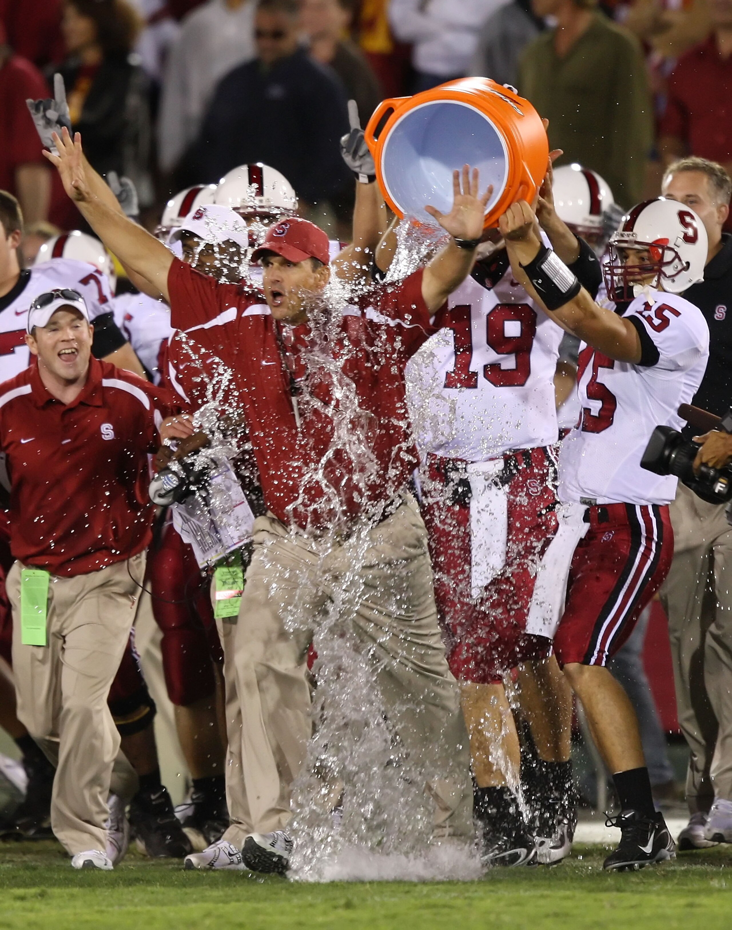 LOS ANGELES - OCTOBER 6:  Alex Loukas #15 celebrates with head coach Jim Harbaugh of the Stanford University Cardinal after defeating the USC Trojans 24-23 at the Los Angeles Memorial Coliseum October 6, 2007 in Los Angeles, California.  (Photo by Lisa Bl