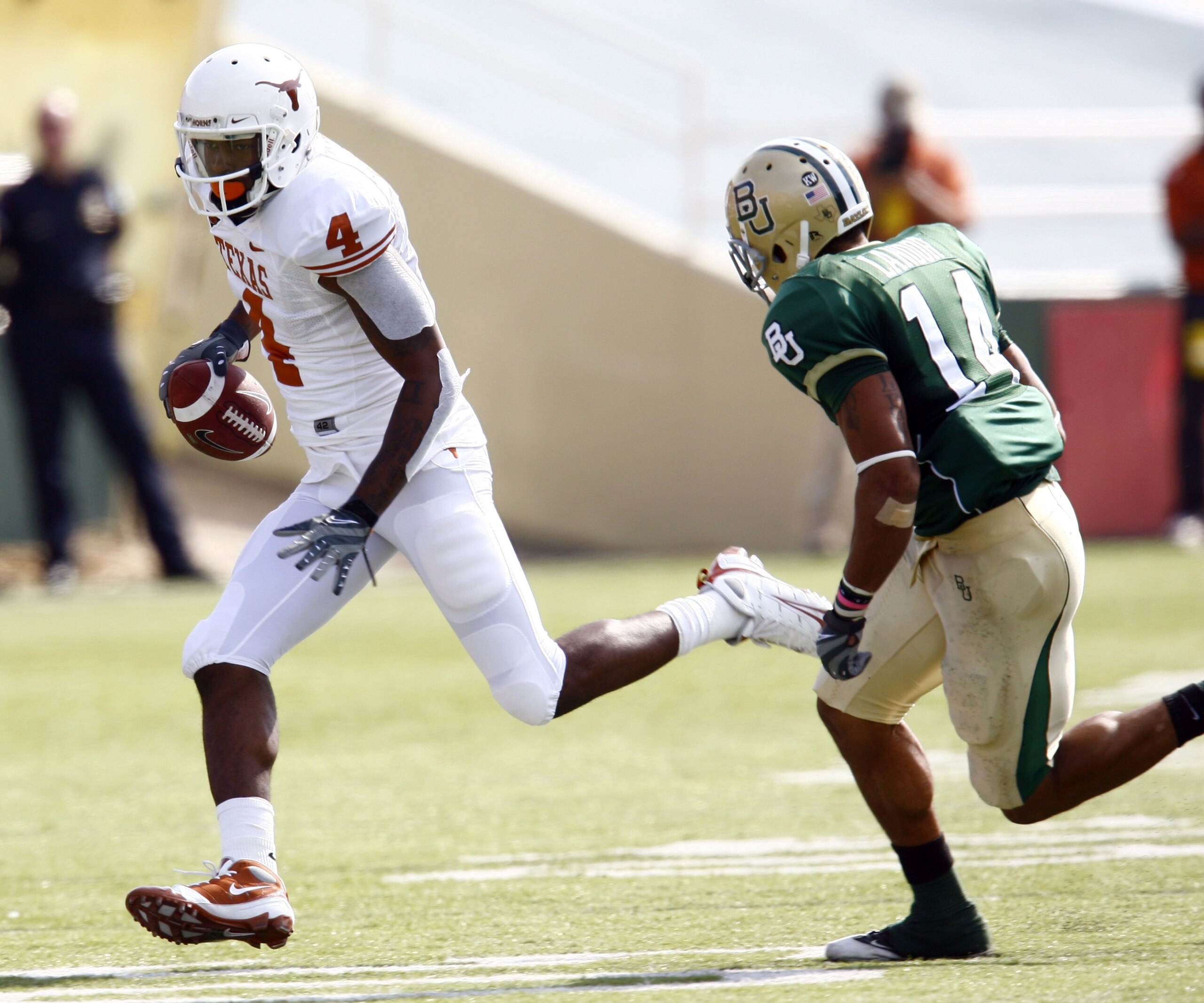 WACO, TX - NOVEMBER 14:  Wide receiver Dan Buckner #4 of the Texas Longhorns carries the ball against safety Byron Landor #14 of the Baylor Bears on November 14, 2009 at Floyd Casey Stadium in Waco, Texas.  The Longhorns beat the Bears 47-14. (Photo by To