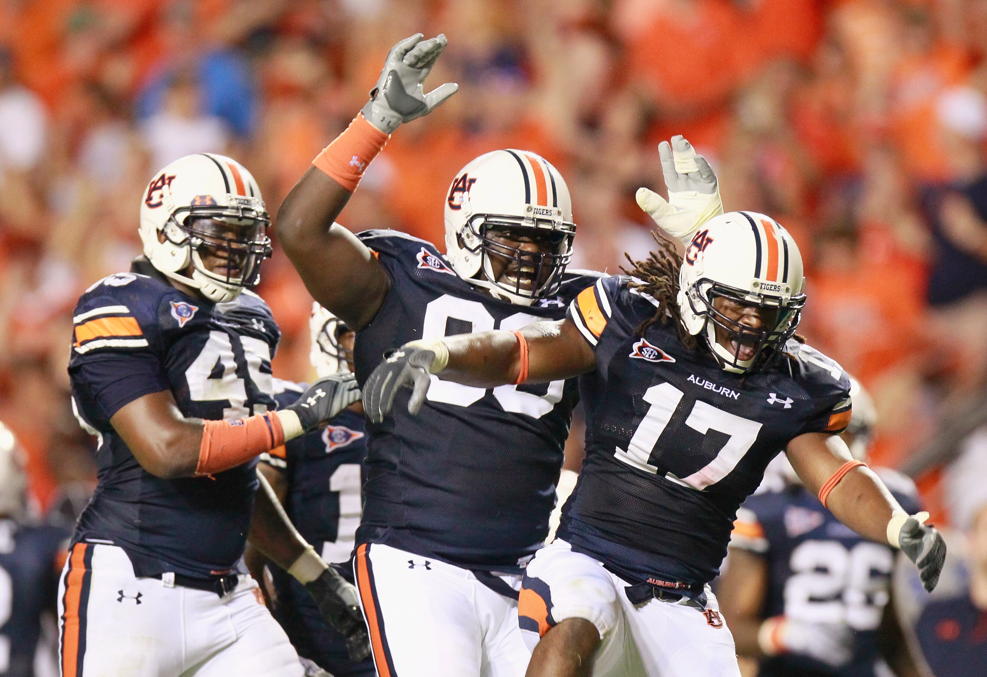 AUBURN, AL - SEPTEMBER 25:  Josh Bynes #17 of the Auburn Tigers reacts after intercepting a pass by the South Carolina Gamecocks with Antoine Carter #45 and Mike Blanc #93 at Jordan-Hare Stadium on September 25, 2010 in Auburn, Alabama.  (Photo by Kevin C