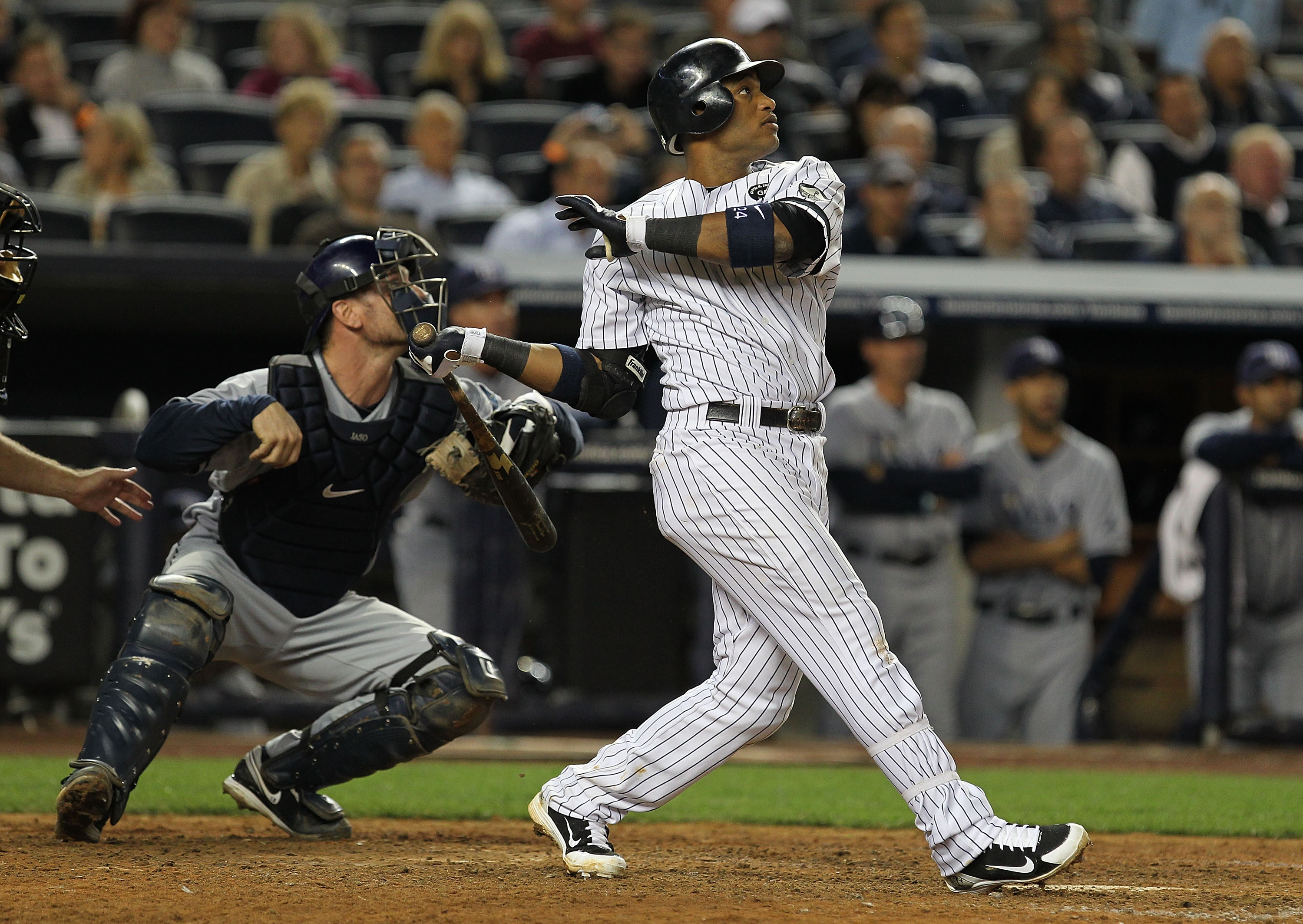 NEW YORK - SEPTEMBER 21:  Robinson Cano #24 of the New York Yankees drives in two runs with a double in the seventh inning against  the Tampa Bay Rays during their game on September 21, 2010 at Yankee Stadium in the Bronx borough of New York City.  (Photo