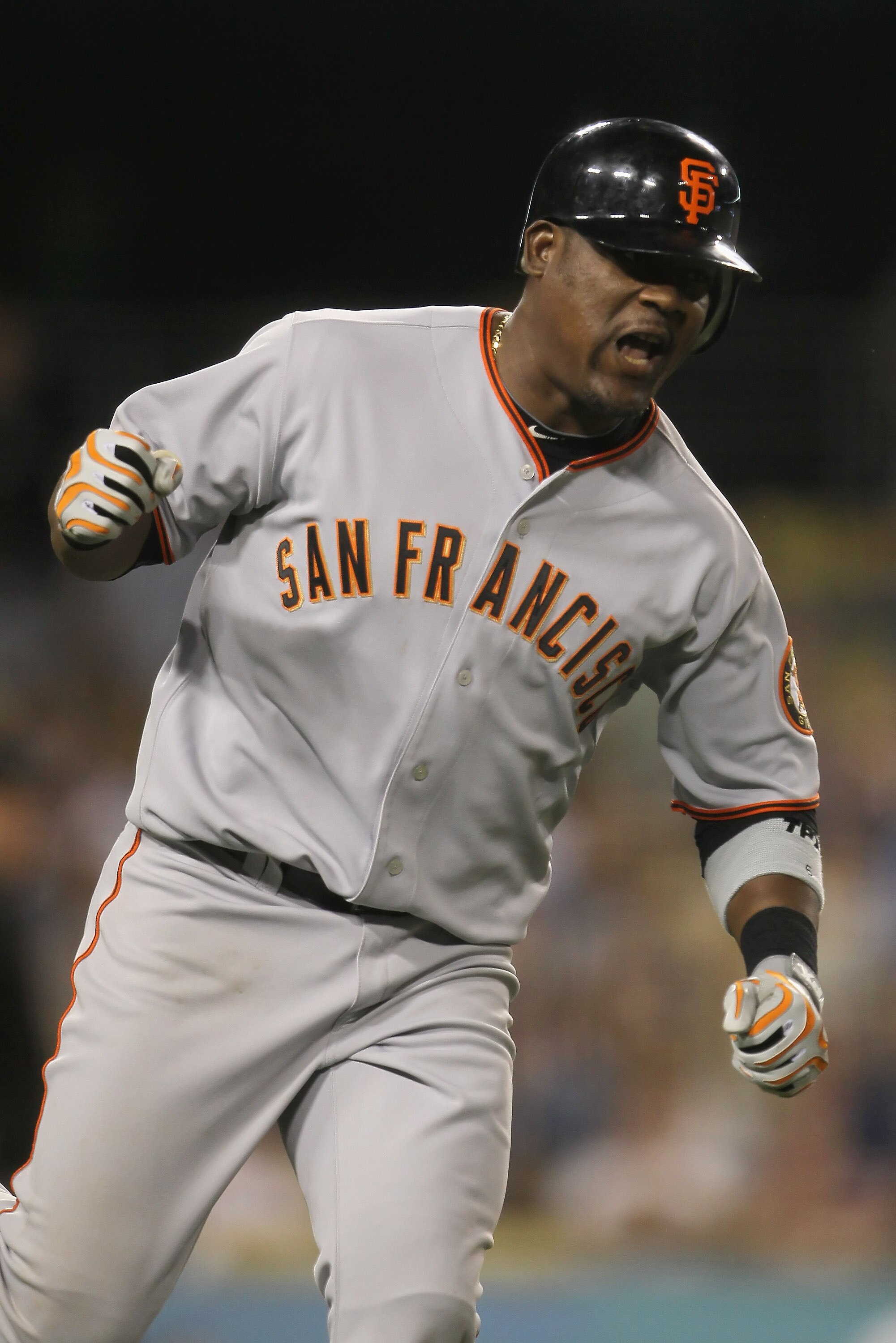 LOS ANGELES, CA - SEPTEMBER 04:  Juan Uribe #5 of the San Francisco Giants celebrates as he rounds first base after hitting a two-run home run against the Los Angeles Dodgers in the ninth inning at Dodger Stadium on September 4, 2010 in Los Angeles, Calif