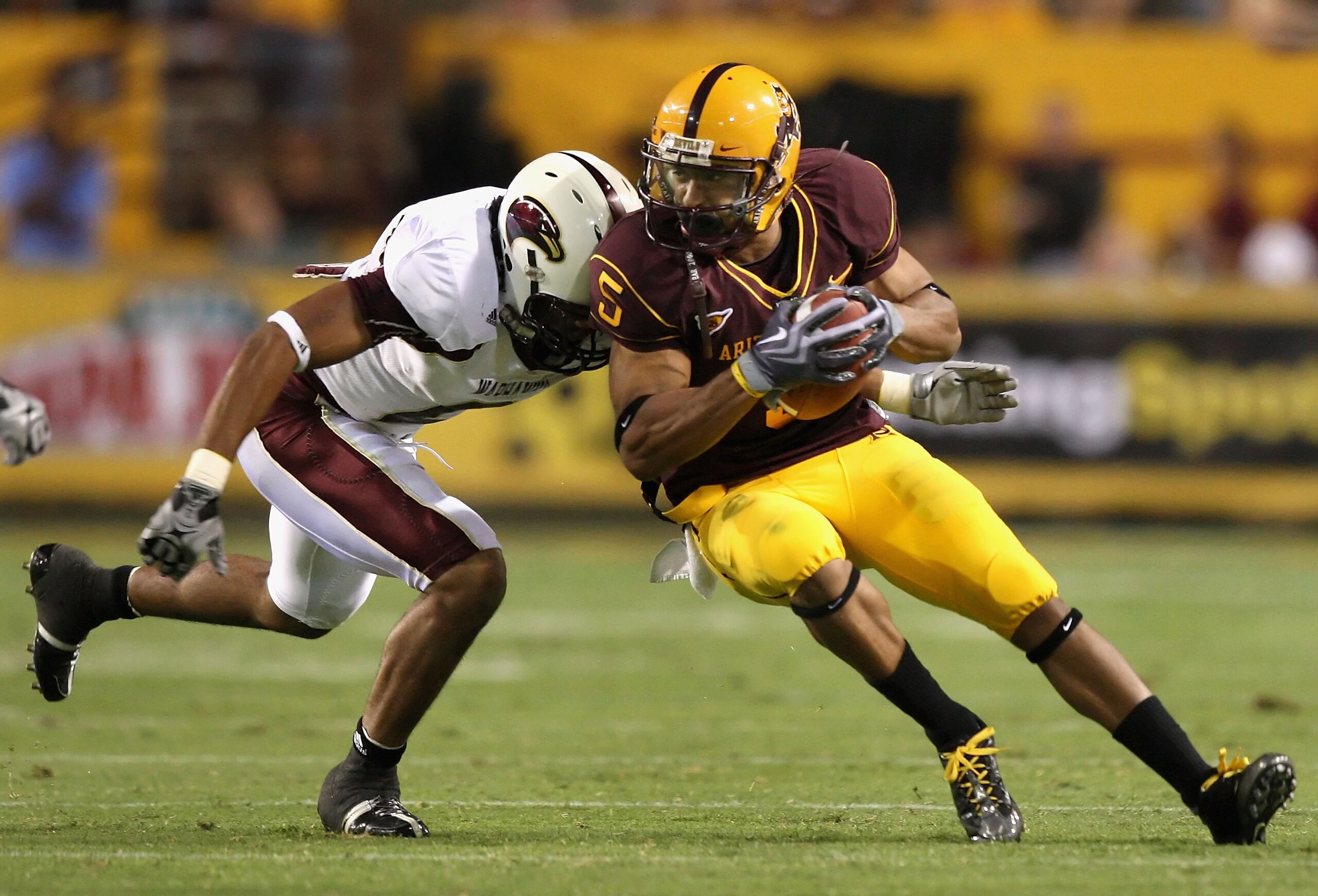 TEMPE, AZ - SEPTEMBER 19:  Wide receiver Kerry Taylor #5 of the Arizona State Sun Devils runs with the ball after a reception past Henry Mitchell #11 of the Louisiana Monroe Warhawks during the college football game at Sun Devil Stadium on September 19, 2
