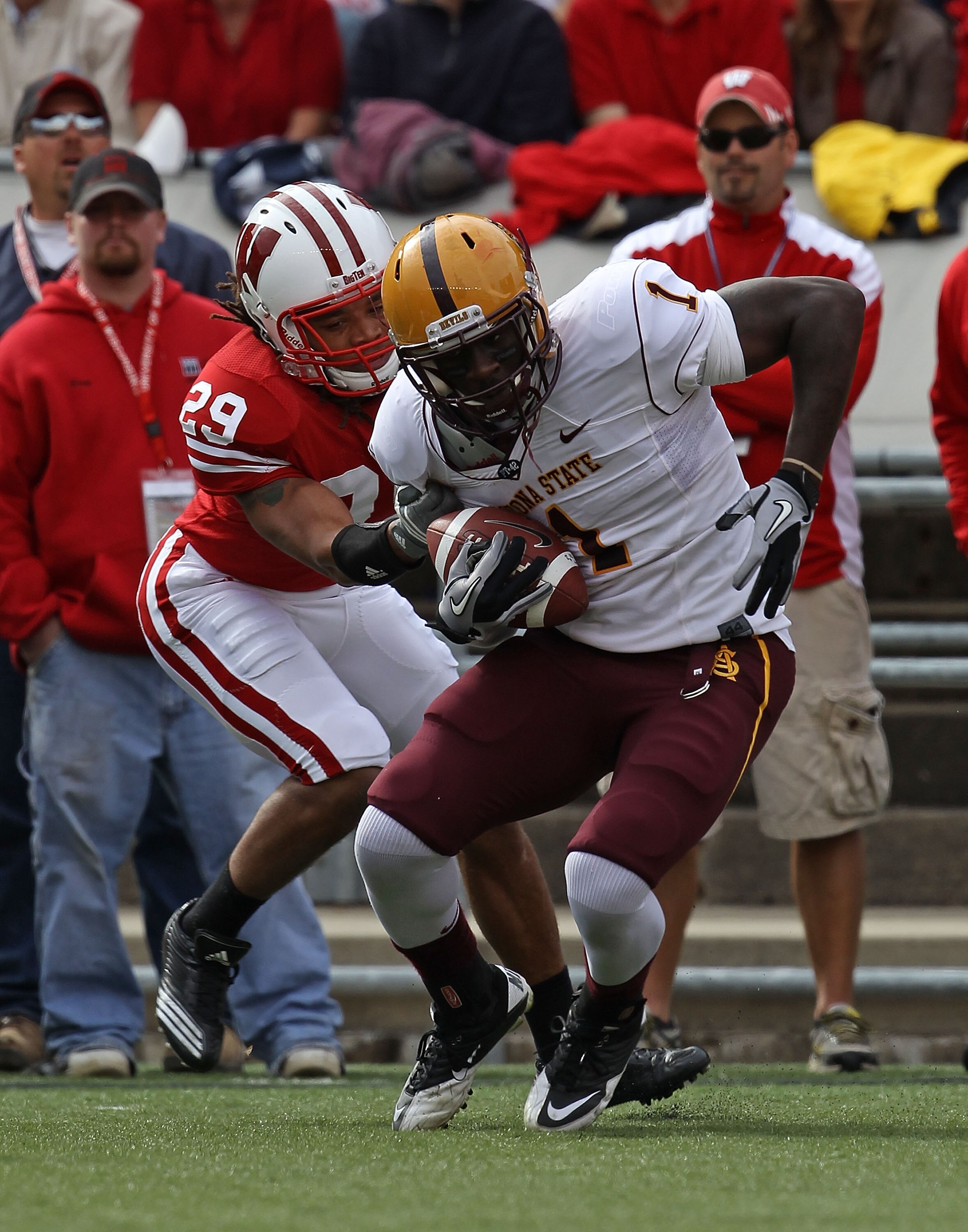 MADISON, WI - SEPTEMBER 18: Mike Willie #1 of the Arizona State Sun Devils tries to escape from Niles Brinkley #29 of the Wisconsin Badgers at Camp Randall Stadium on September 18, 2010 in Madison, Wisconsin. Wisconsin defeated Arizona State 20-19.  (Phot