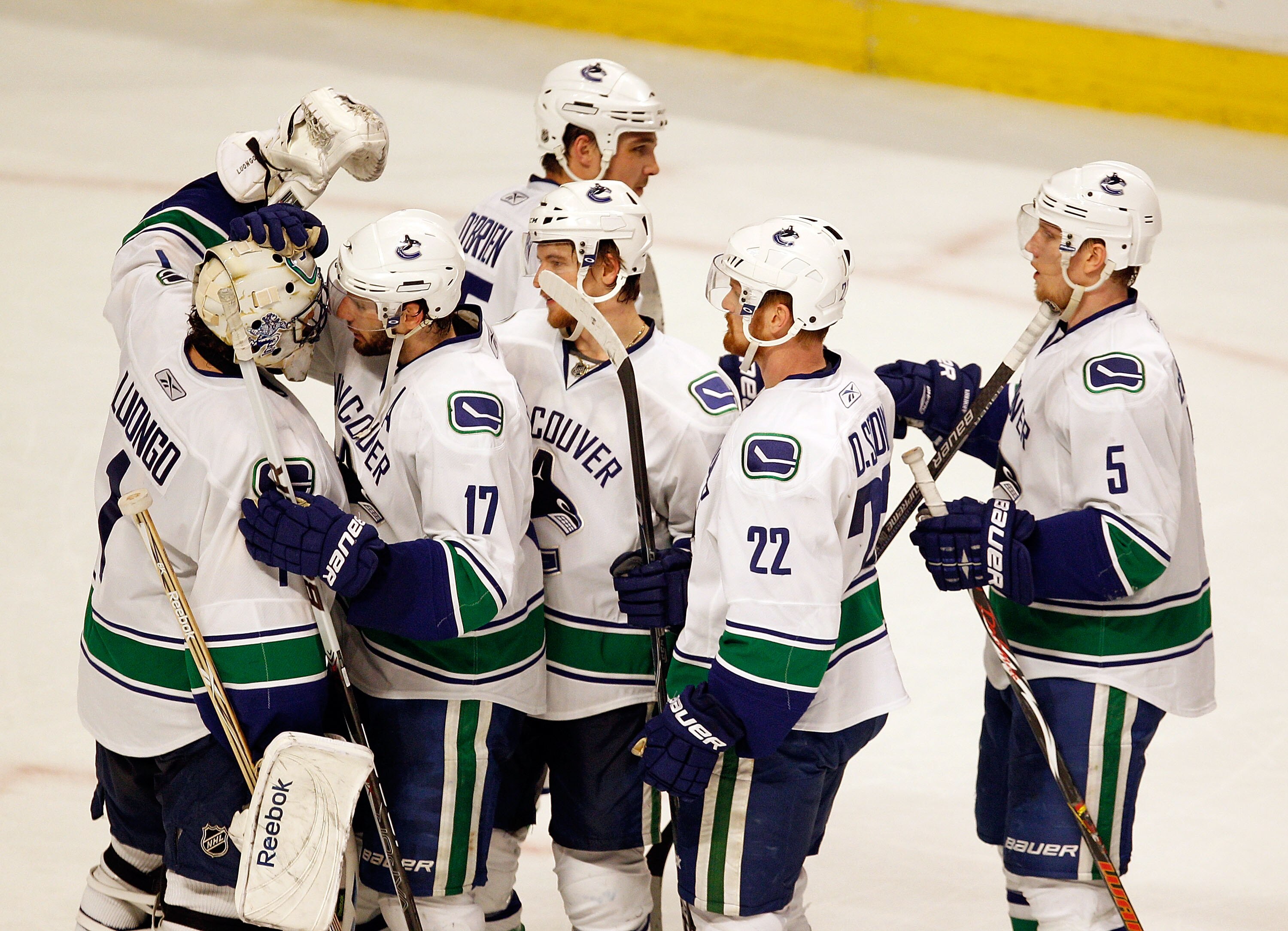 CHICAGO - MAY 09: Ryan Kesler #17 of the Vancouver Canucks congratulates goalie Roberto Luongo #1 after a win over the Chicago Blackhawks while teammates including Daniel Sedin #22 and Christian Ehrhoff #5 wait in line after Game Five of the Western Confe