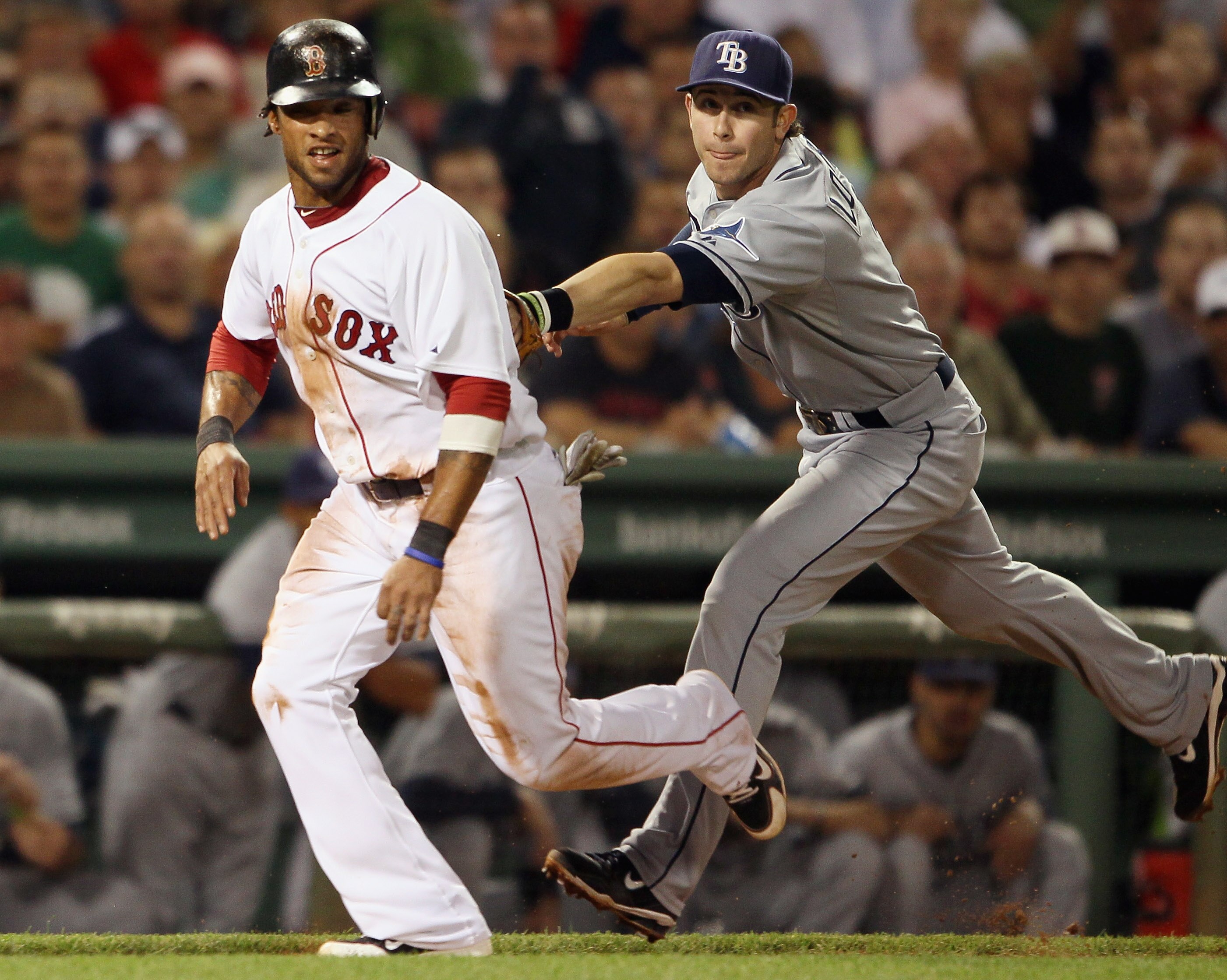 BOSTON - SEPTEMBER 07:  Darnell McDonald #54 of the Boston Red Sox is tagged out by Evan Longoria #3 of the Tampa Bay Rays on September 7, 2010 at Fenway Park in Boston, Massachusetts.  (Photo by Elsa/Getty Images)