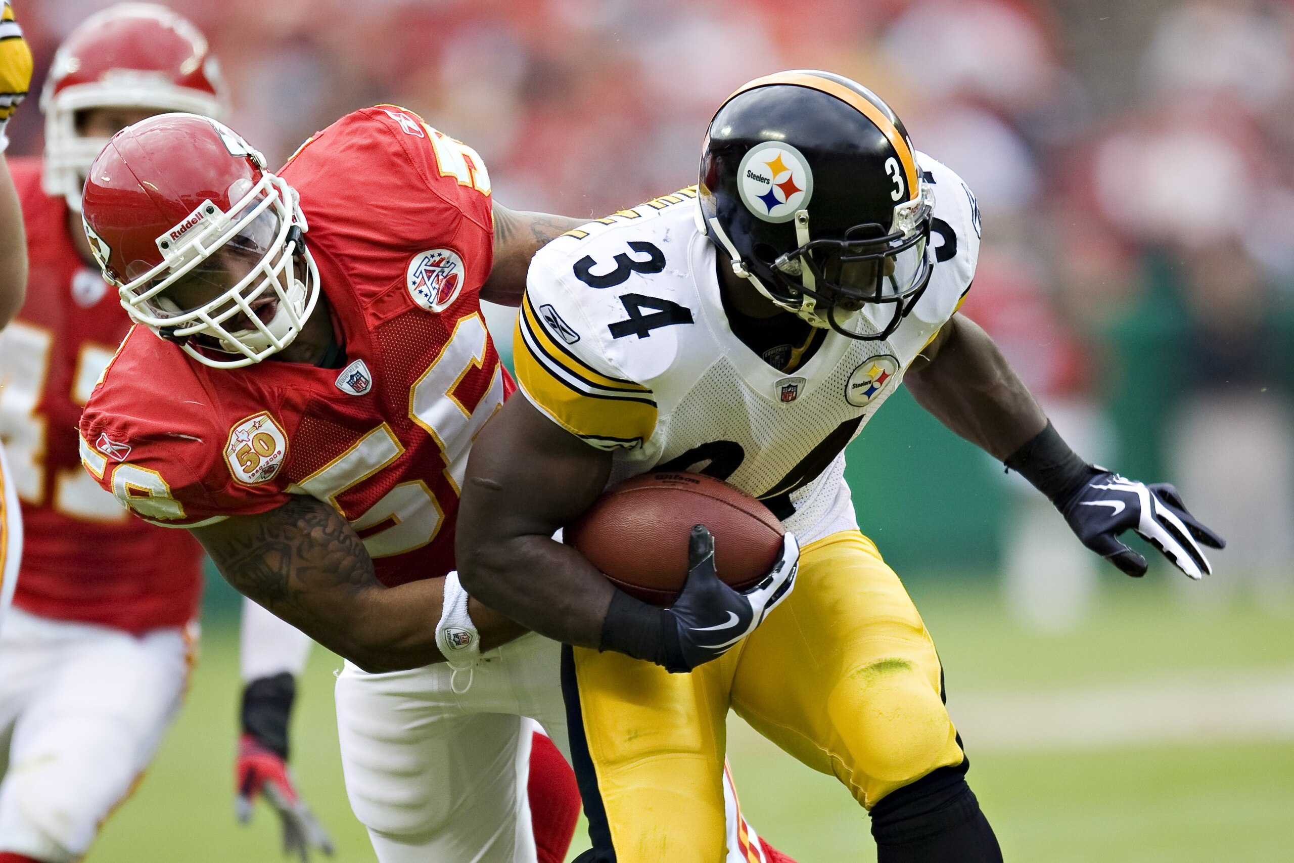 KANSAS CITY, MO - NOVEMBER 22:  Running back Rashard Mendenhall #34 of the Pittsburgh Steelers is tackled by Derrick Johnson #56 of the Kansas City Chiefs at Arrowhead Stadium on November 22, 2009 in Kansas City, Missouri.  The Chiefs defeated the Steeler