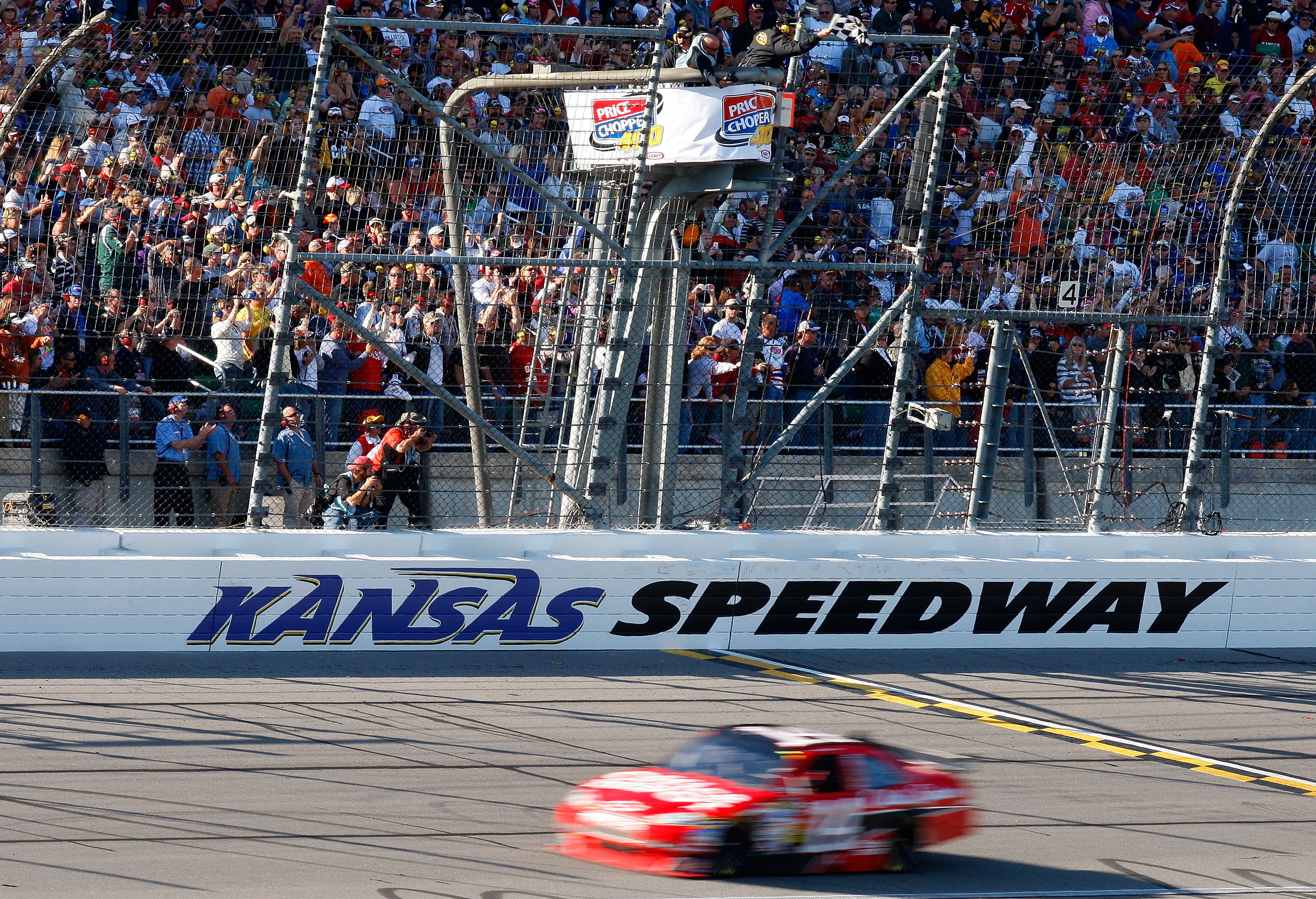 KANSAS CITY, KS - OCTOBER 04:  Tony Stewart, driver of the #14 Office Depot/Old Spice Chevrolet, crosses the start/finish line to take the checkered flag and win the NASCAR Sprint Cup Series Price Chopper 400 presented by Kraft Foods at the Kansas Speedwa