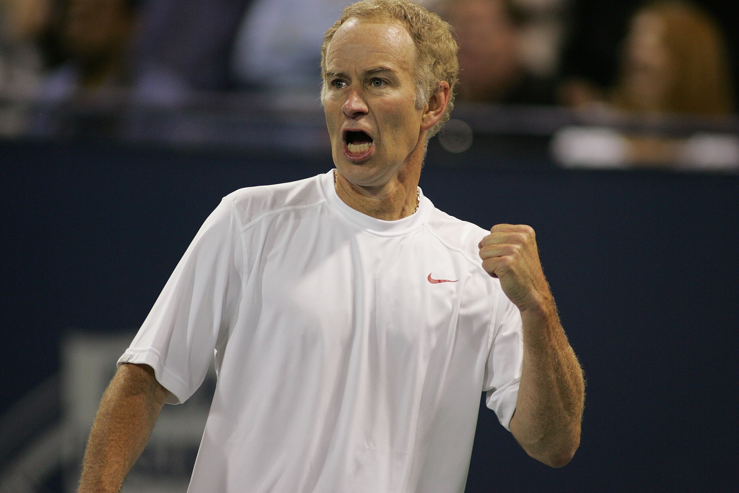 LOS ANGELES, CA - JULY 24:  John McEnroe reacts after wining a point against Andre Agassi during the Stars Under the Stars gala on July 24, 2010 at the Los Angeles Tennis Center in Los Angeles, California.  Andre Agassi defeated John McEnroe 6-4, 6-2.  (P