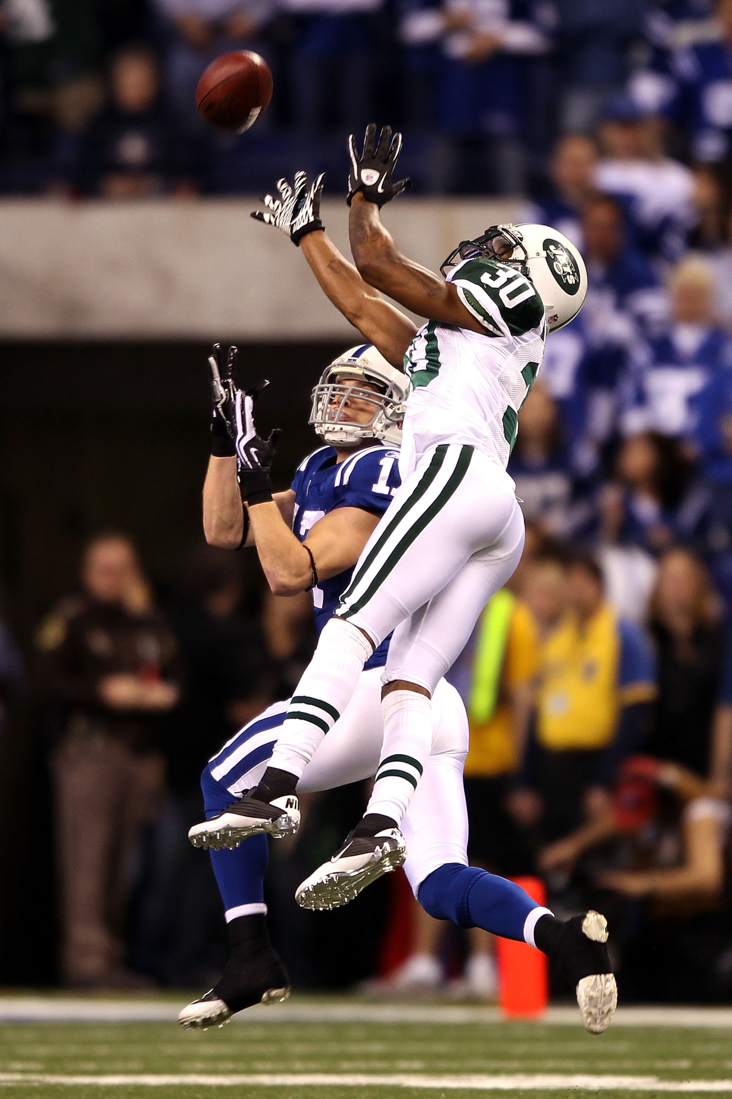 INDIANAPOLIS - JANUARY 24: Austin Collie #17 of the Indianapolis Colts waits for the pass while being defended by Drew Coleman #30 of the New York Jets during the AFC Championship Game at Lucas Oil Stadium on January 24, 2010 in Indianapolis, Indiana. ( INDIANAPOLIS - JANUARY 24: Austin Collie #17 of the Indianapolis Colts waits for the pass while being defended by Drew Coleman #30 of the New York Jets during the AFC Championship Game at Lucas Oil Stadium on January 24, 2010 in Indianapolis, Indiana. (