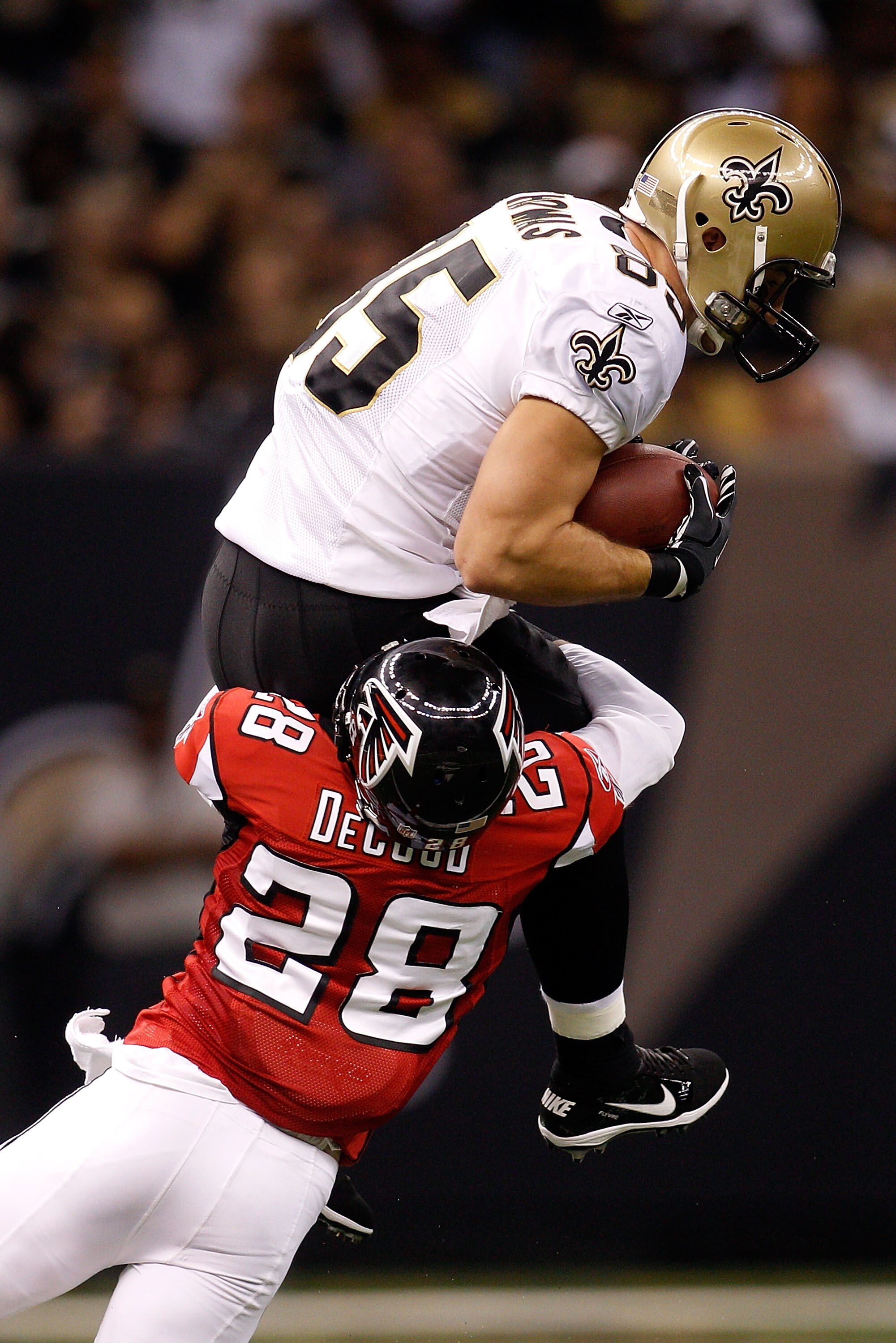 NEW ORLEANS - SEPTEMBER 26:  David Thomas #85 of the New Orleans Saints is tackled as he makes a catch over Thomas DeCoud #28 of the Atlanta Falcons at the Louisiana Superdome on September 26, 2010 in New Orleans, Louisiana.  (Photo by Chris Graythen/Gett