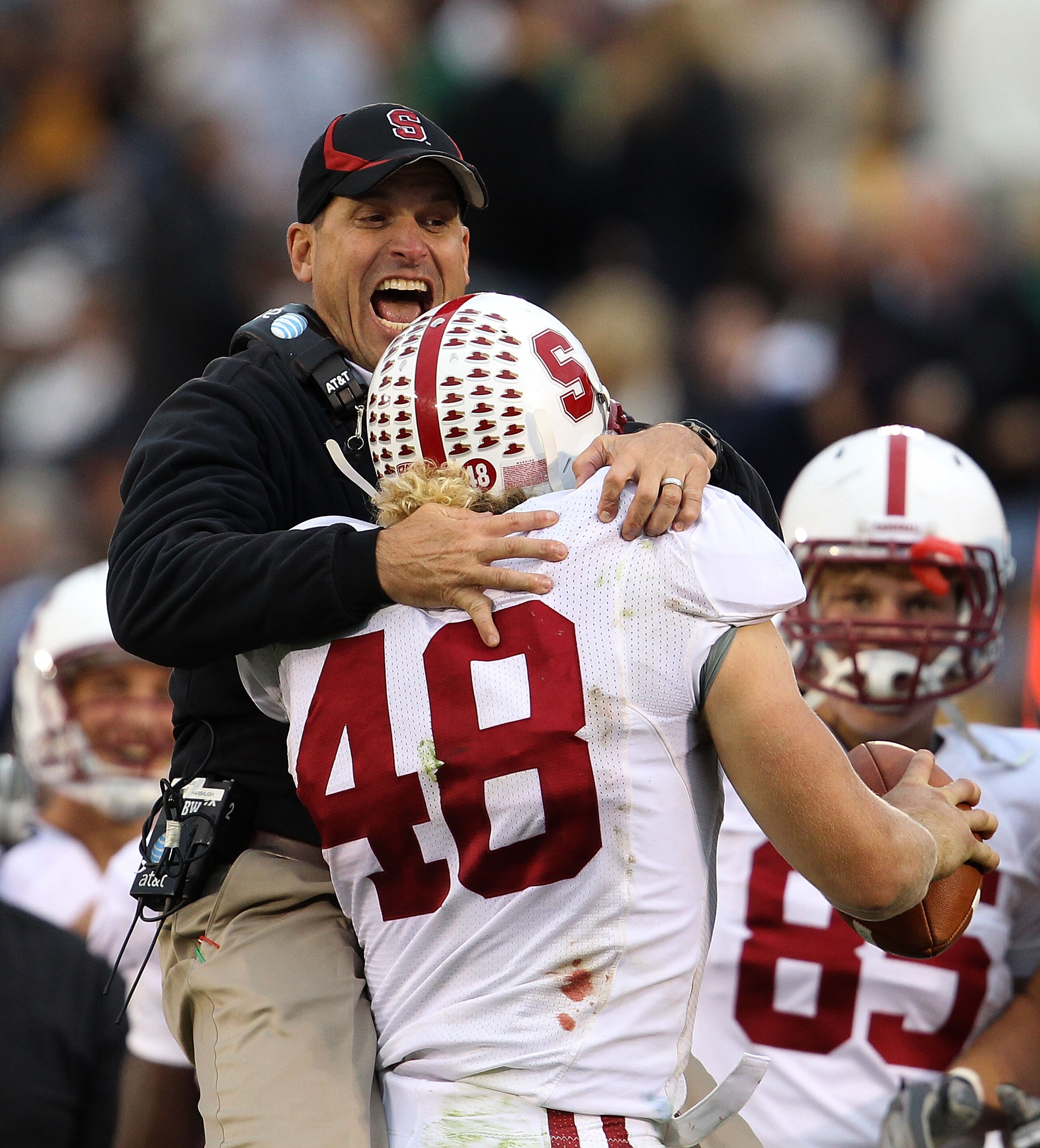 SOUTH BEND, IN - SEPTEMBER 25: Head coach Jim Harbaugh of the Stanford Cardinal jumps to greet Owen Marecic #48 after Marecic intercepted a pass for a touchdown against the Notre Dame Fighting Irish at Notre Dame Stadium on September 25, 2010 in South Ben