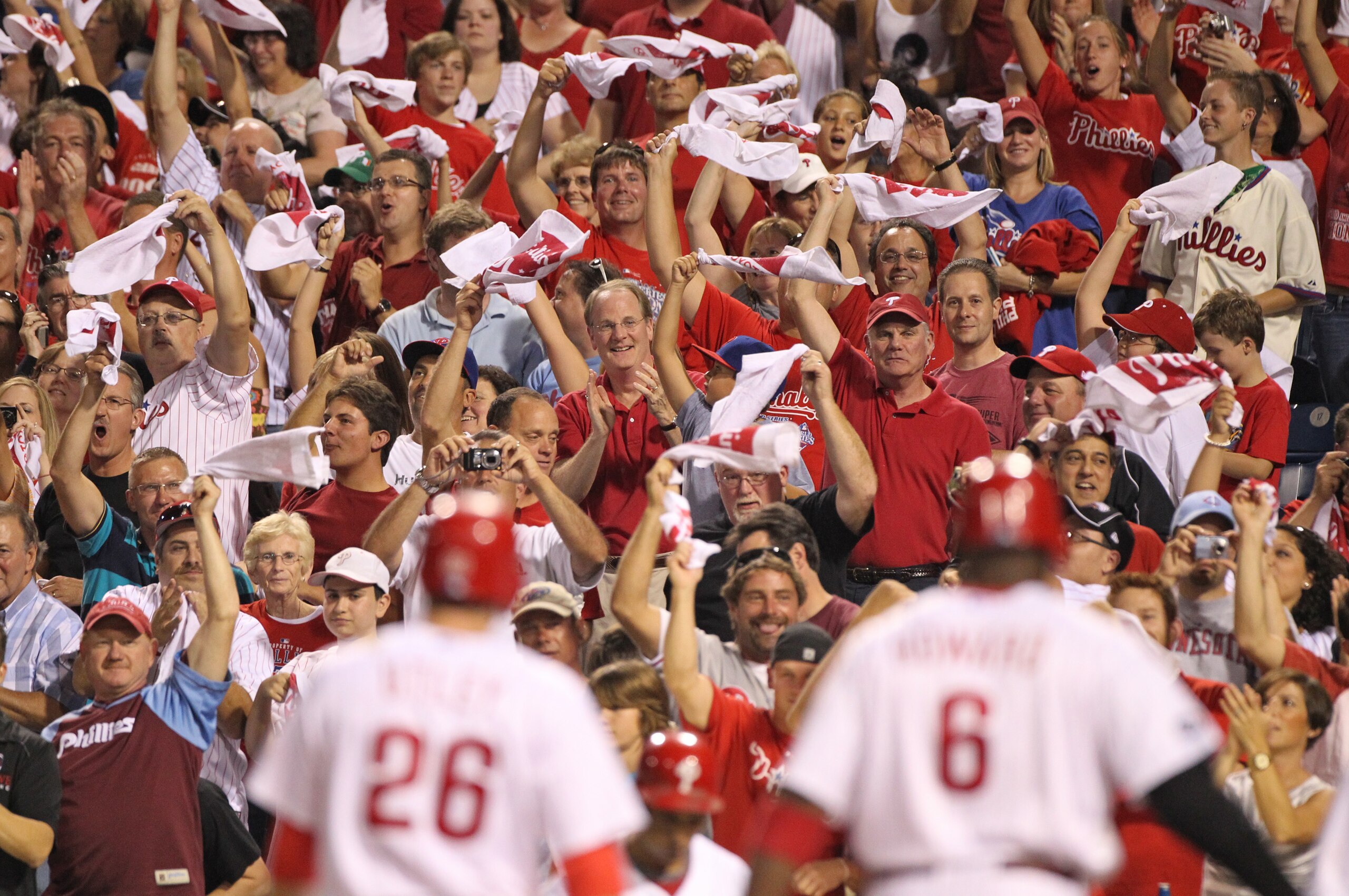 PHILADELPHIA - SEPTEMBER 25: Fans cheer second baseman Chase Utley #26 and first baseman Ryan Howard #6 of the Philadelphia Phillies after Howard's two-run home run in the first inning of a game against the New York Mets at Citizens Bank Park on September