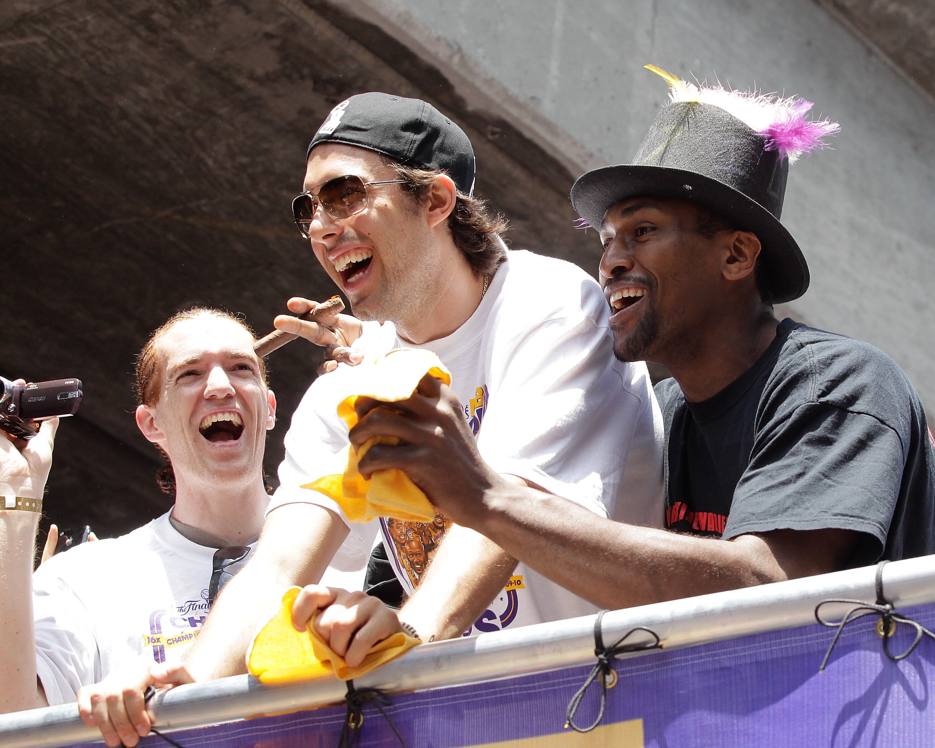 LOS ANGELES, CA - JUNE 21:  Los Angeles Lakers shooting guard Sasha Vujacic (C) and small forward Ron Artest (R) laugh while riding in the victory parade for the the NBA basketball champion team on June 21, 2010 in Los Angeles, California. The Lakers beat