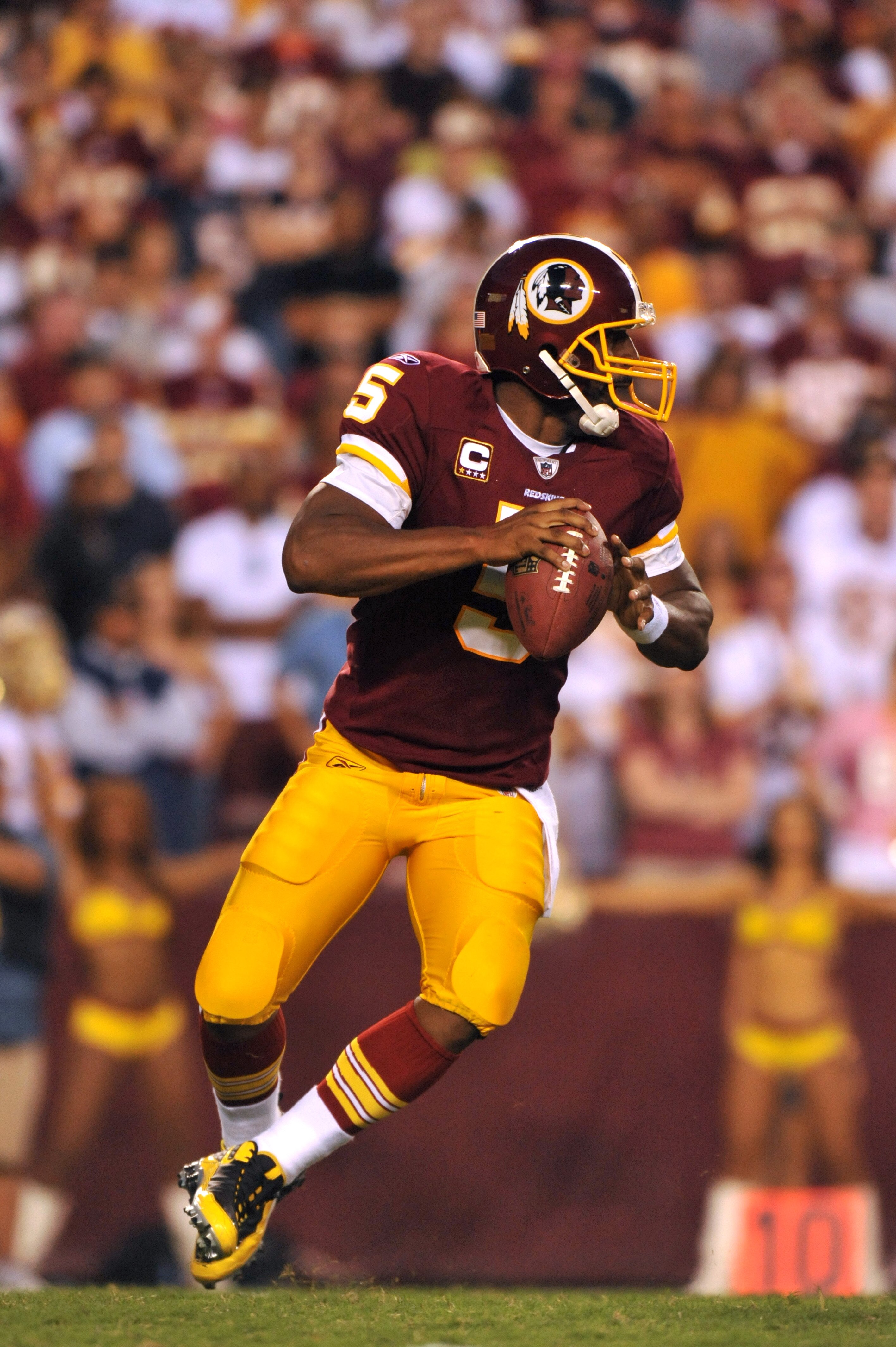 LANDOVER, MD - SEPTEMBER 19:  Donovan McNabb #5 of the Washington Redskins looks for a receiver during the game against the Houston Texans at FedExField on September 19, 2010 in Landover, Maryland. The Texans defeated the Redskins in overtime 30-27. (Phot