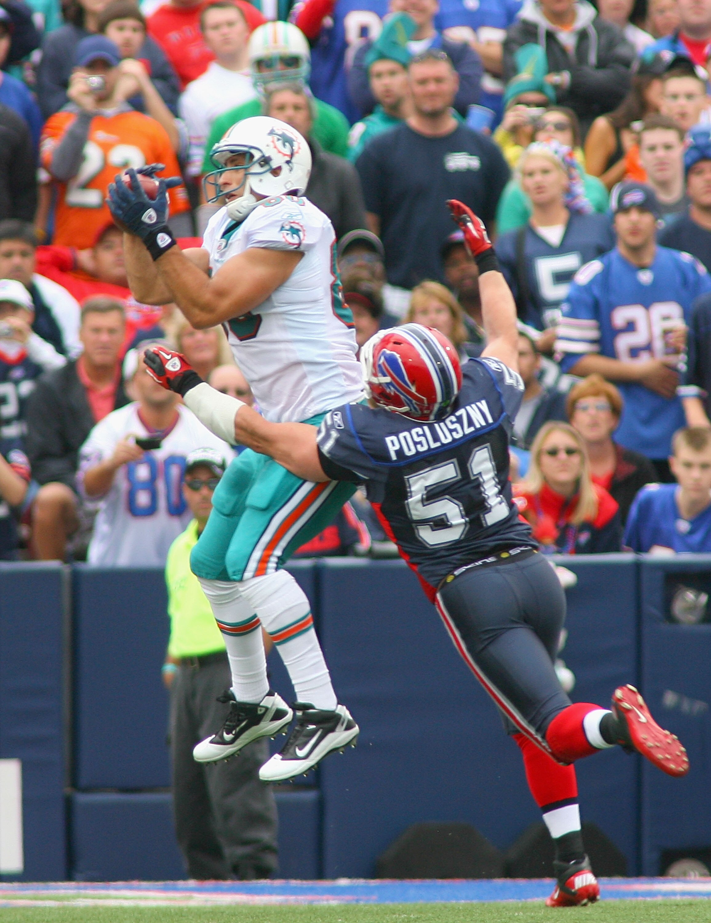 ORCHARD PARK, NY - SEPTEMBER 12:  Anthony Fasano # 80 of the Miami Dolphins makes a catch at the 2 yard line against Paul Posluszny #51 of  the Buffalo Bills during the NFL season opener at Ralph Wilson Stadium on September 12, 2010 in Orchard Park, New Y