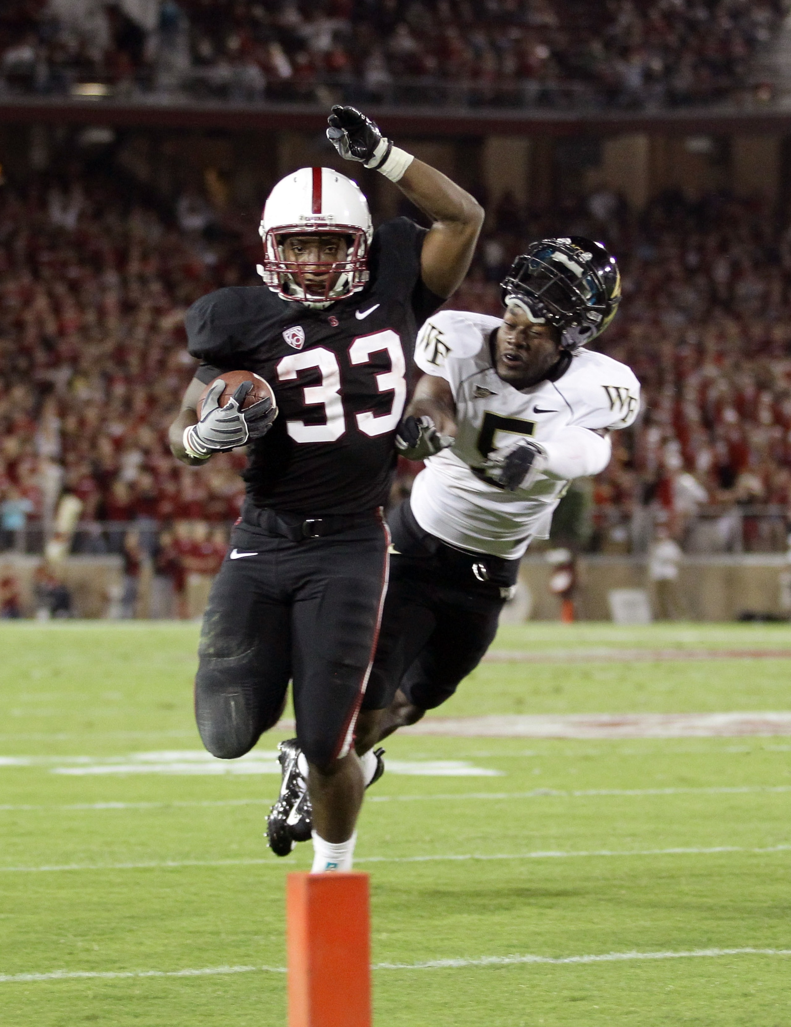 PALO ALTO, CA - SEPTEMBER 18:  Cyhl Quarles #5 of the Wake Forest Demon Deacons loses his helmet as he tries to tackle Stepfan Taylor #33 of the Stanford Cardinal at Stanford Stadium on September 18, 2010 in Palo Alto, California.  (Photo by Ezra Shaw/Get