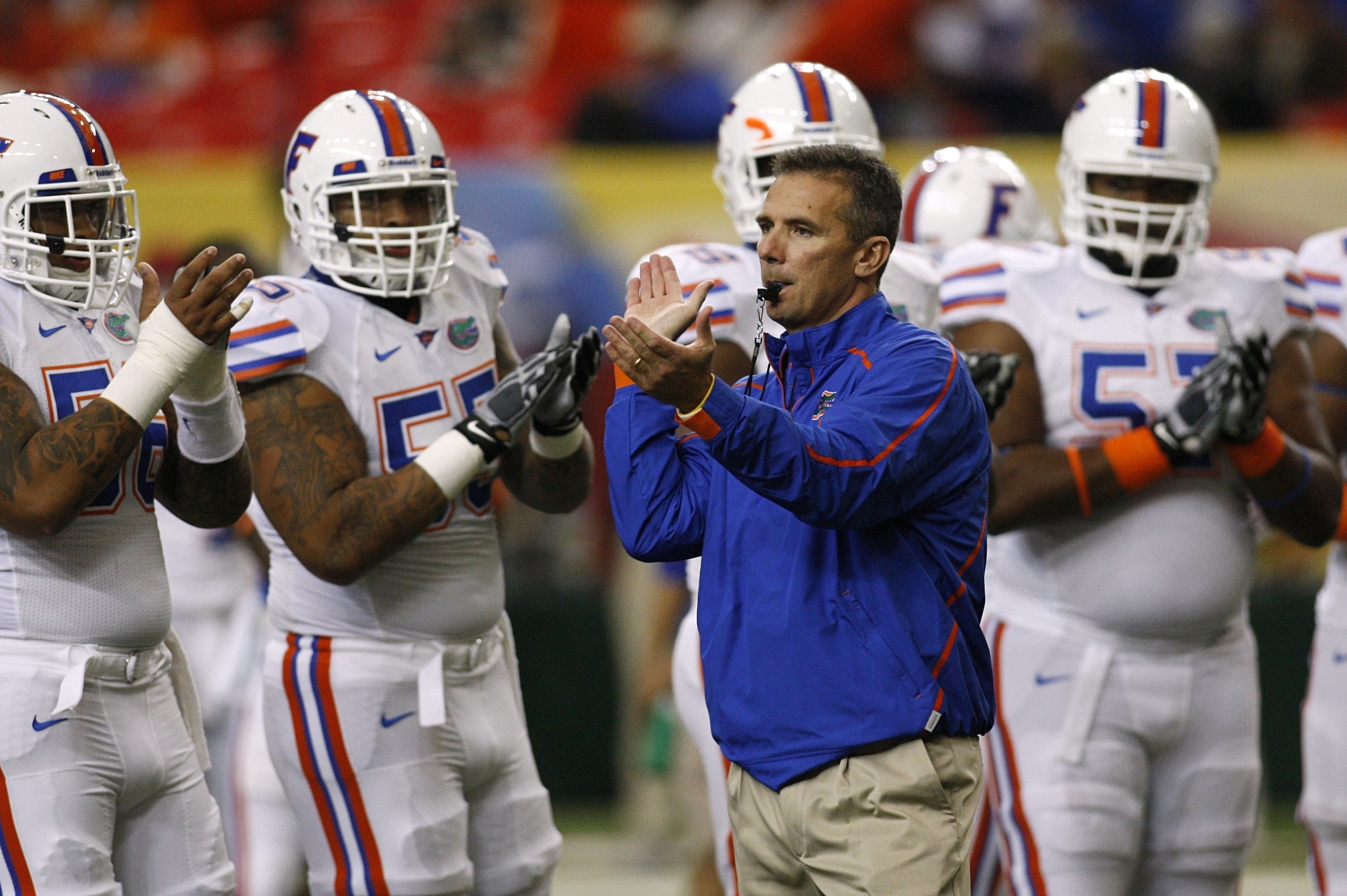 ATLANTA - DECEMBER 5:  Head coach Urban Meyer of the Florida Gators encourages his players during warm ups against the Alabama Crimson Tide during the SEC Championship game at Georgia Dome on December 5, 2009 in Atlanta, Georgia.  (Photo by Chris Graythen