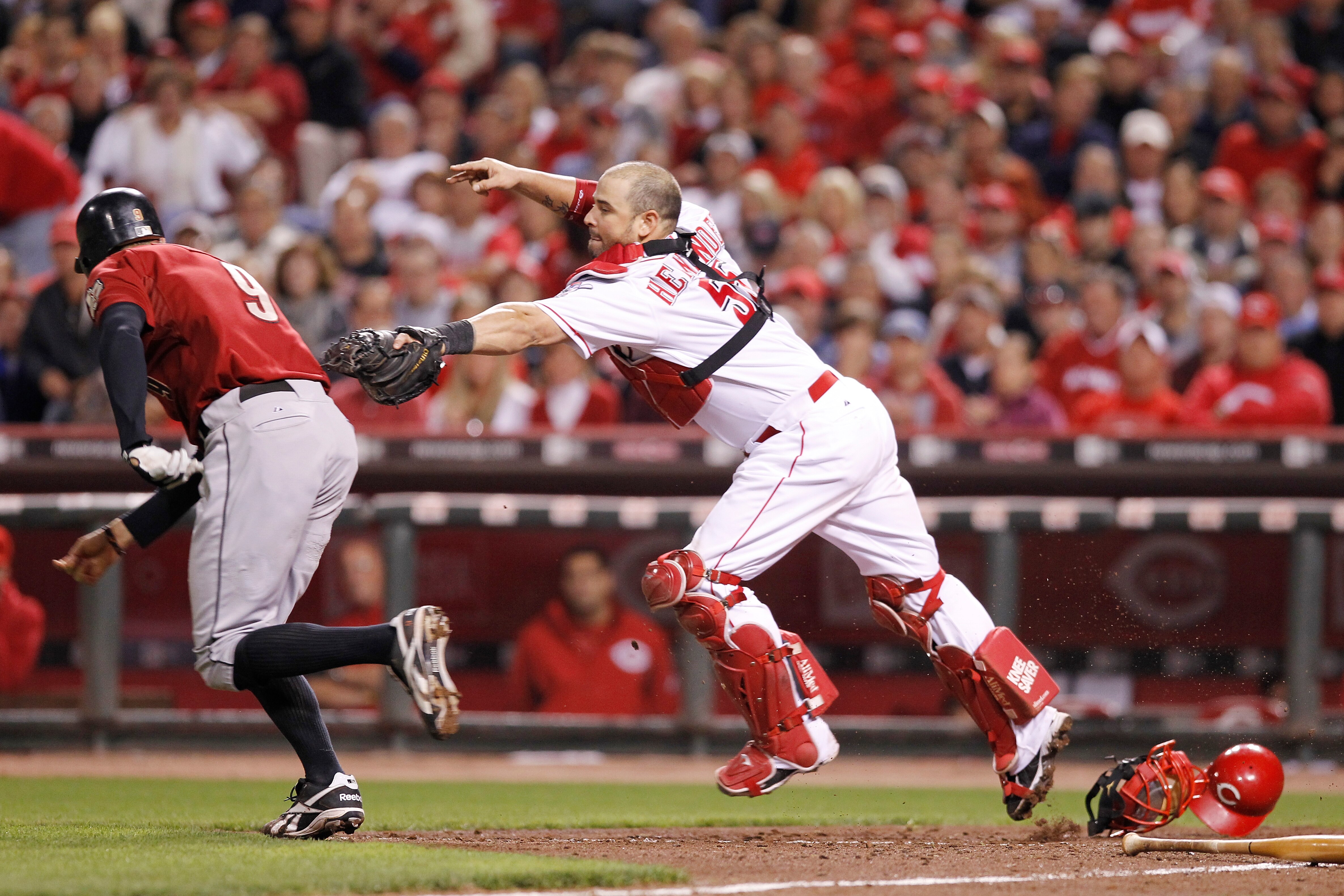 CINCINNATI, OH - SEPTEMBER 28: Ramon Hernandez #55 of the Cincinnati Reds tags out Hunter Pence #9 of the Houston Astros after he struck out at Great American Ball Park on September 28, 2010 in Cincinnati, Ohio. The Reds won 3-2 to clinch the NL Central D