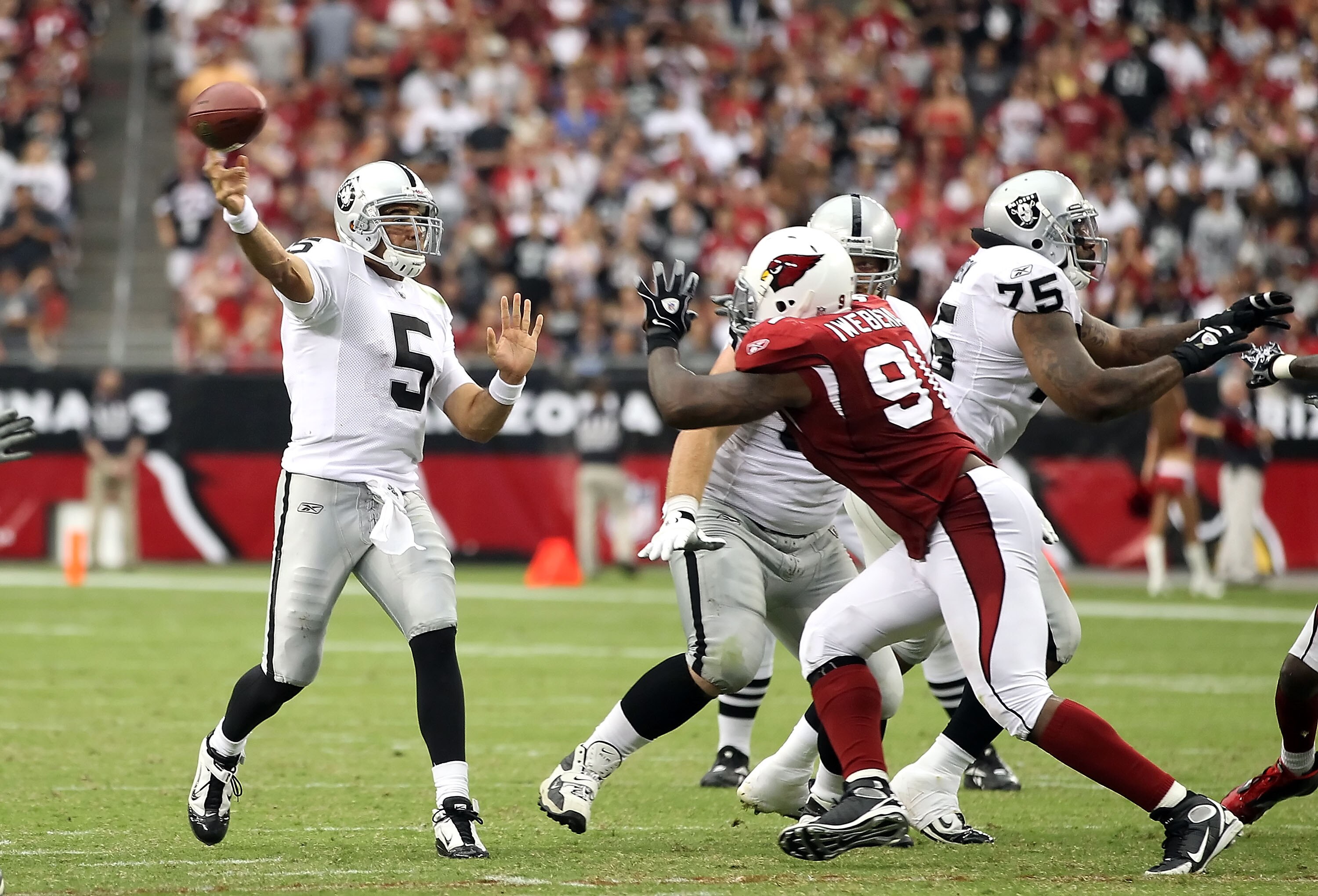 GLENDALE, AZ - SEPTEMBER 26:  Quarterback Bruce Gradkowski #5 of the Oakland Raiders throws a pass during the NFL game against the Arizona Cardinals at the University of Phoenix Stadium on September 26, 2010 in Glendale, Arizona.  The Cardinals defeated t