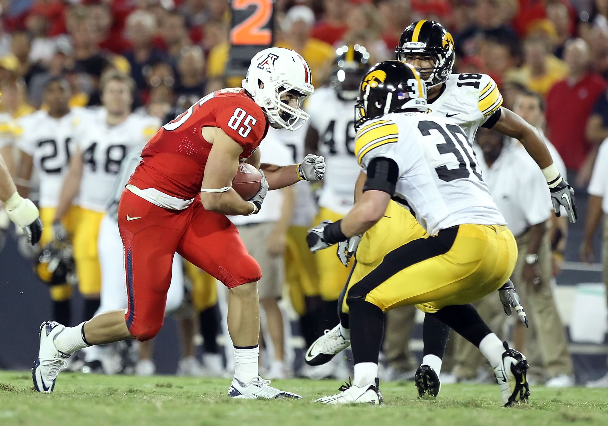 TUCSON, AZ - SEPTEMBER 18:  Wide receiver David Douglas #85 of the Arizona Wildcats runs with the ball after a reception against the Iowa Hawkeyes during the college football game at Arizona Stadium on September 18, 2010 in Tucson, Arizona. The Wildcats d