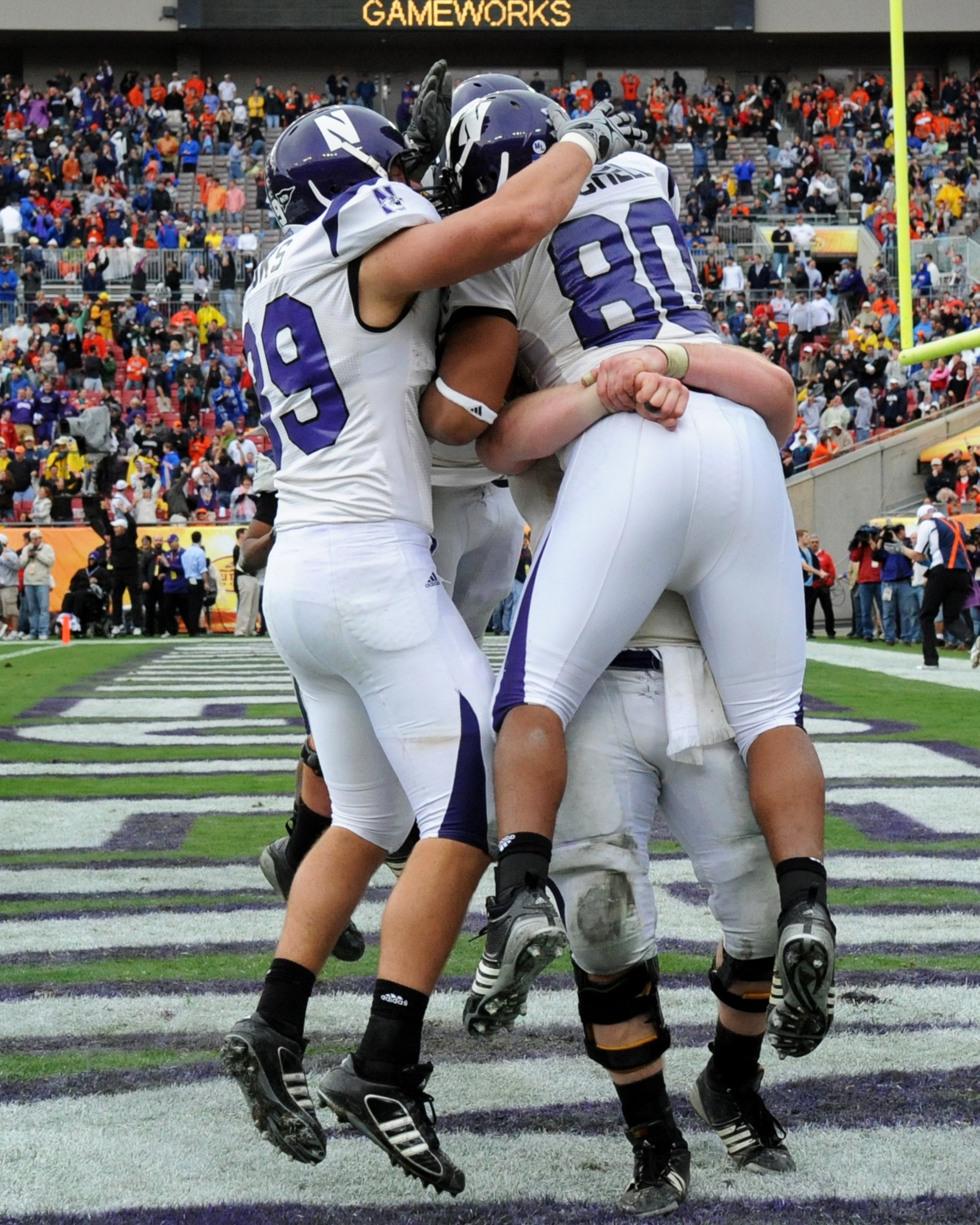TAMPA, FL - JANUARY 1: Players of the Northwestern Wildcats celebrate a touchdown against the Auburn Tigers in the Outback Bowl January 1, 2010 at Raymond James Stadium in Tampa, Florida.  (Photo by Al Messerschmidt/Getty Images)