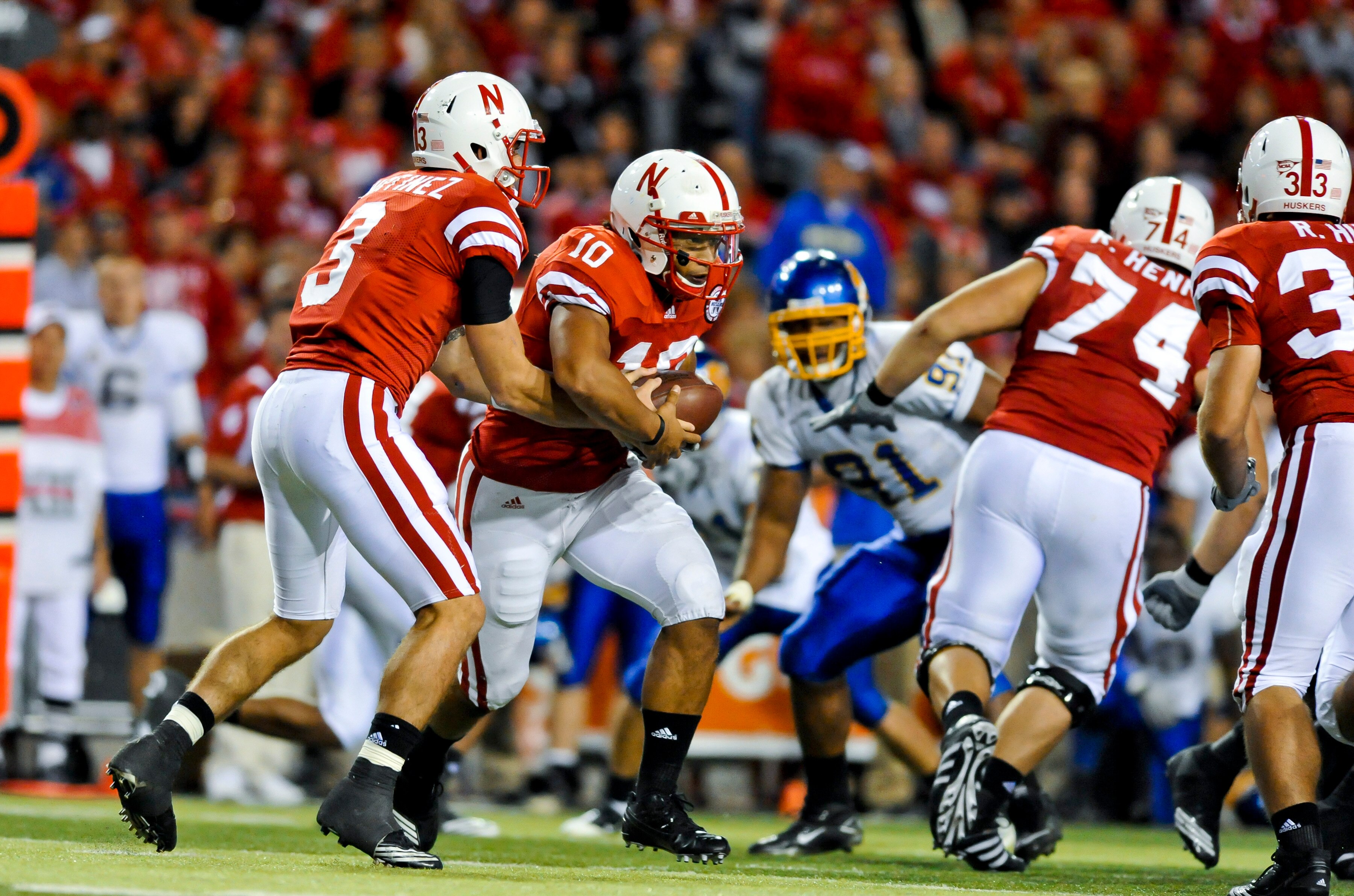 LINCOLN, NEBRASKA - SEPTEMBER 25: Nebraska Cornhuskers quarterback Taylor Martinez #3 hands the ball to running back Roy Helu Jr. #10 during second half action of their game at Memorial Stadium on September 25, 2010 in Lincoln, Nebraska. Nebraska Defeated