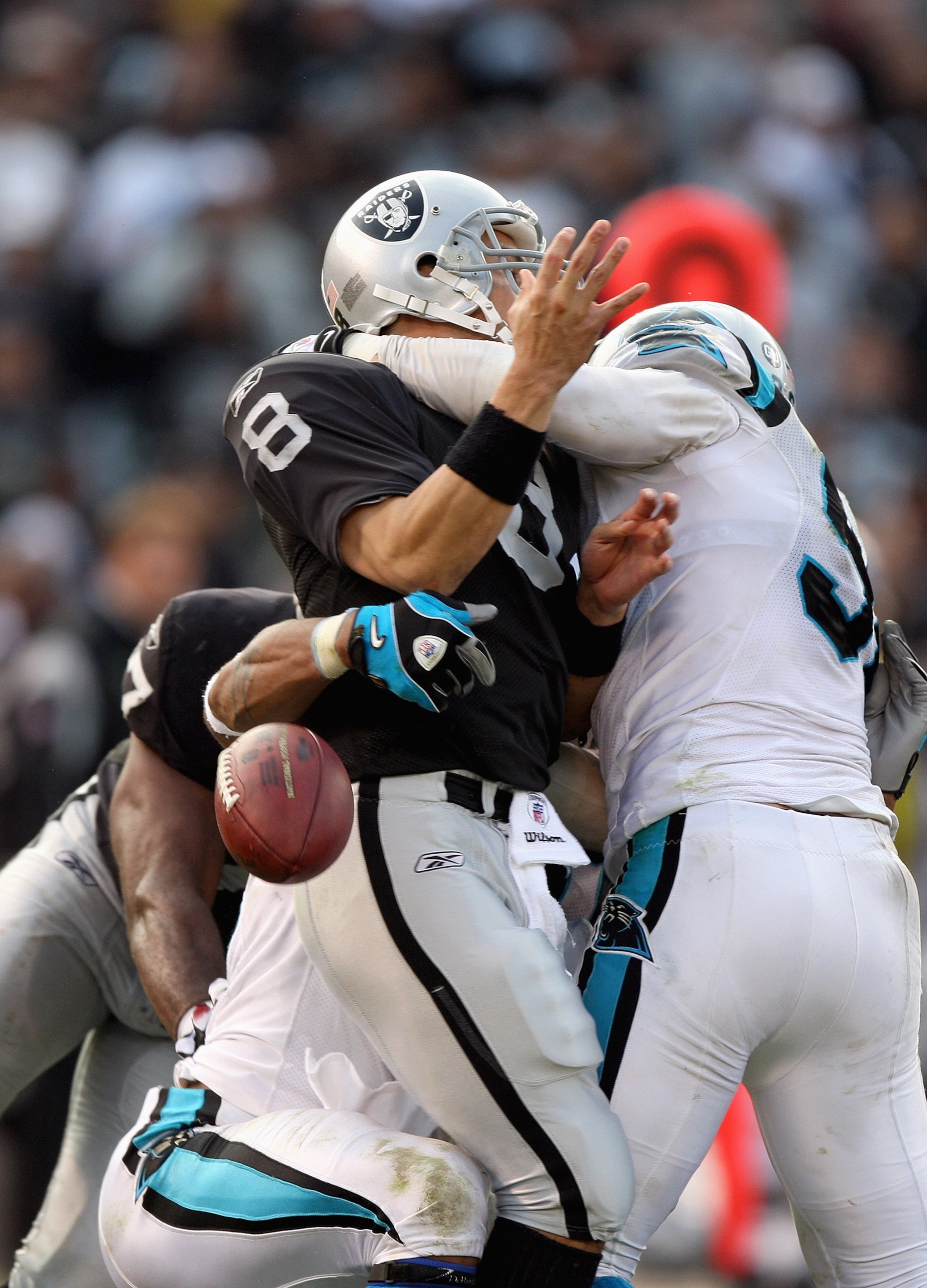 OAKLAND, CA - NOVEMBER 9:  Quarterback Marques Tuiasosopo #8 of the Oakland Raiders drops the ball as he is sacked during the game against the Carolina Panthers at the Oakland-Alameda County Coliseum on November 9, 2008 in Oakland, California. (Photo by J