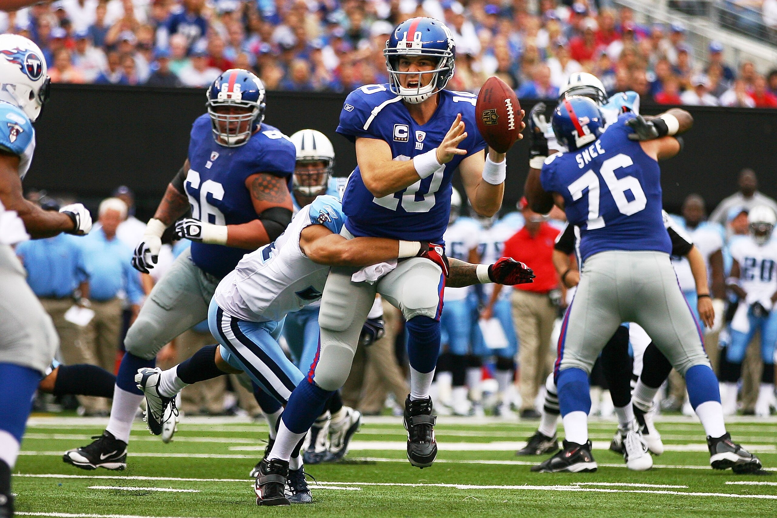 EAST RUTHERFORD, NJ - SEPTEMBER 26:  Eli Manning #10 of the New York Giants throws an interception in the endzone while being sacked by Cortland Finnegan #31 of the Tennessee Titans in the first quarter at New Meadowlands Stadium on September 26, 2010 in