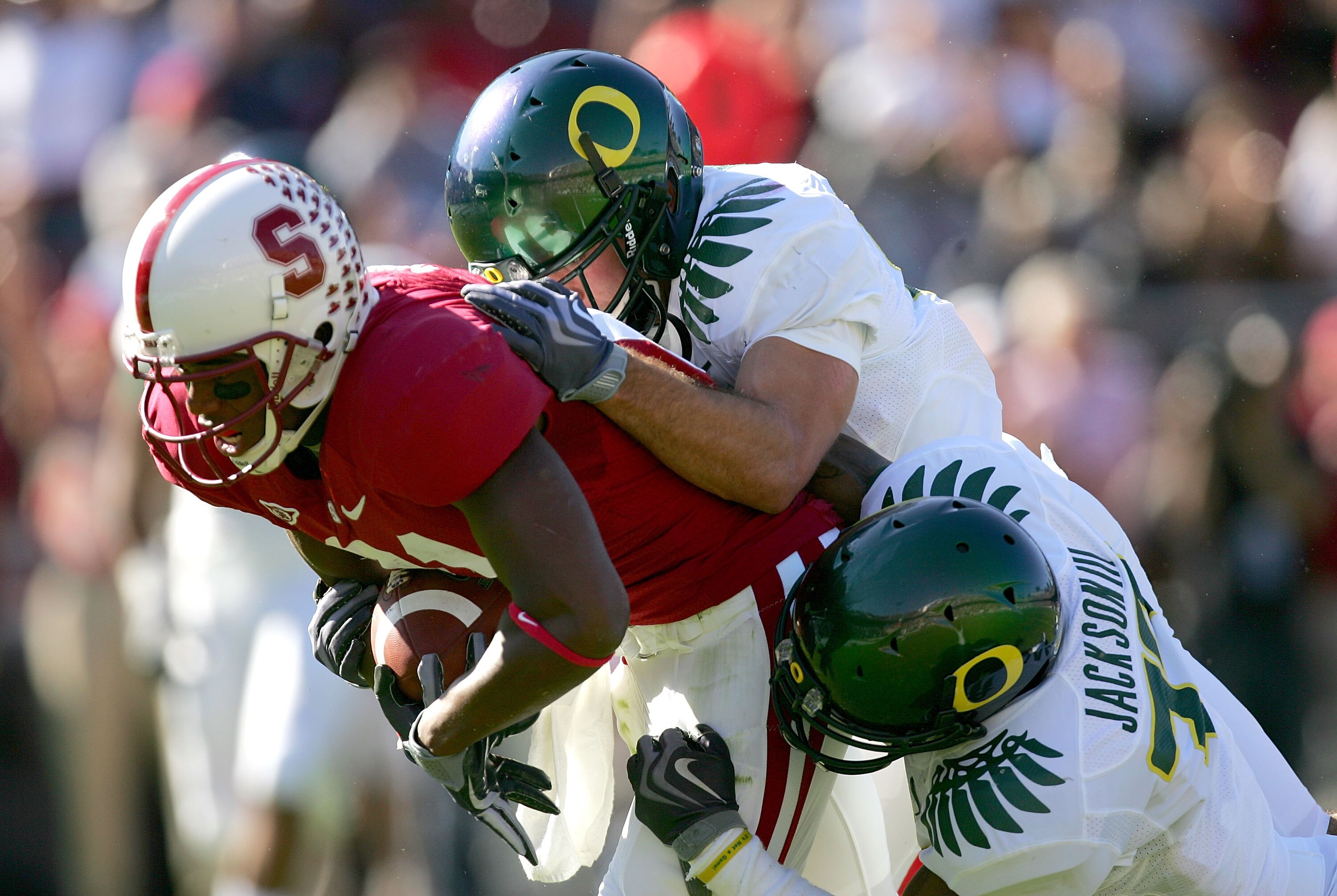 PALO ALTO, CA - NOVEMBER 07:  Chris Owusu #81 of the Stanford Cardinal is tackled by the Oregon Ducks at Stanford Stadium on November 7, 2009 in Palo Alto, California.  (Photo by Ezra Shaw/Getty Images)