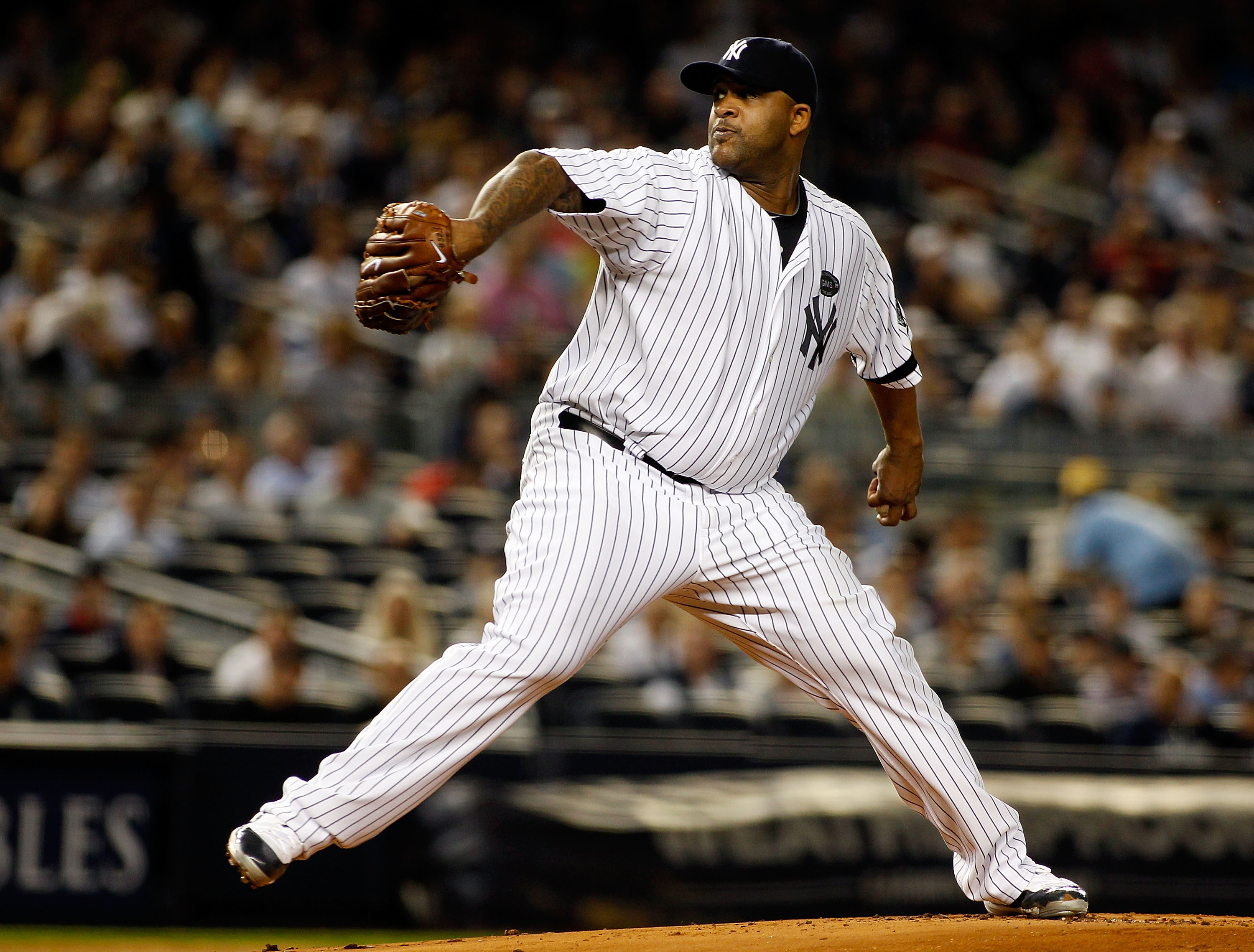 NEW YORK - SEPTEMBER 23:  CC Sabathia #52 of the New York Yankees delivers a pitch in the first-inning against the Tampa Bay Rays on September 23, 2010 at Yankee Stadium in the Bronx borough of New York City.  (Photo by Mike Stobe/Getty Images)