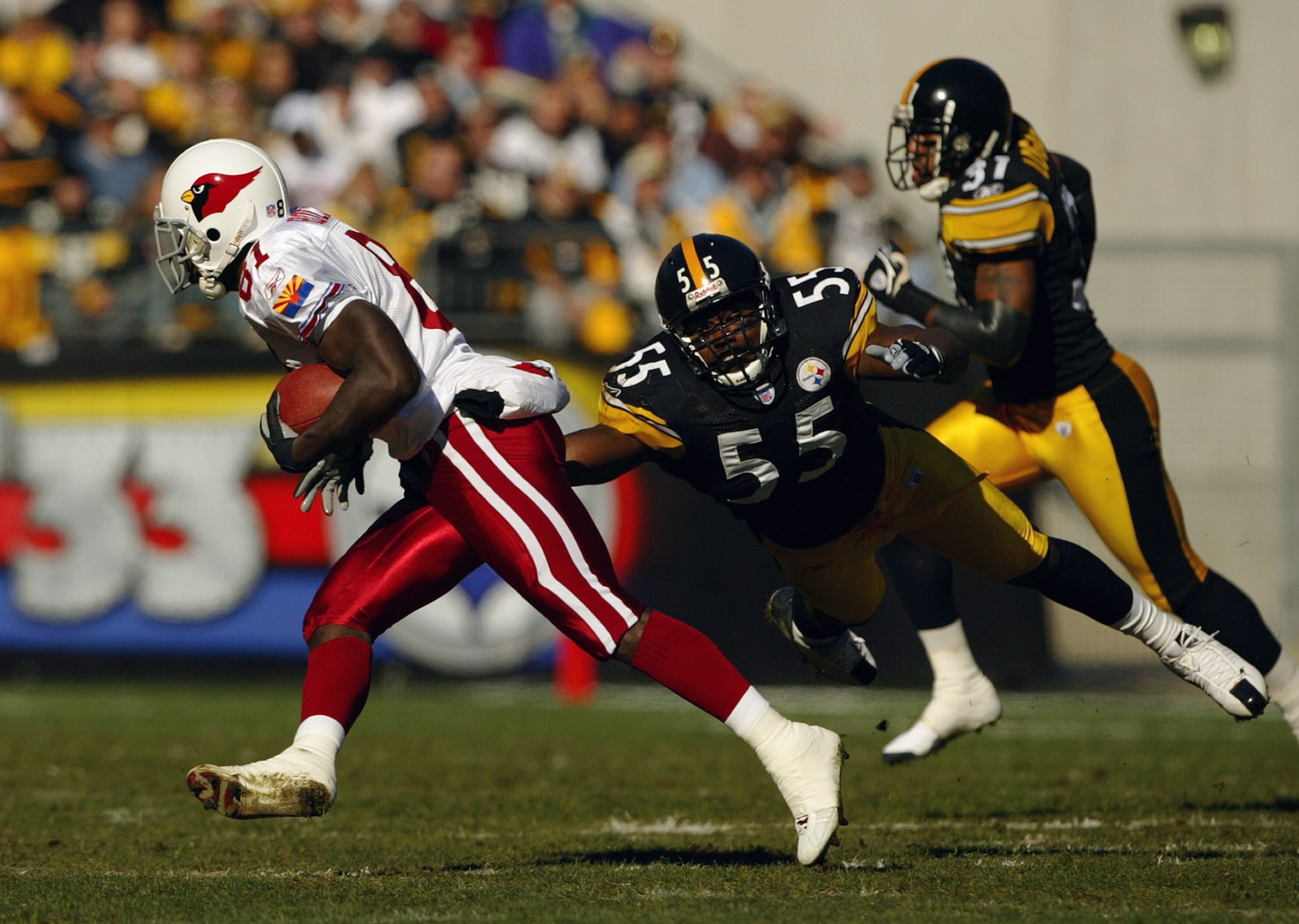 PITTSBURGH - NOVEMBER 9:  Linebacker Joey Porter #55 of the Pittsburgh Steelers attempts to tackle wide receiver Anquan Boldin #81 during the game against the Arizona Cardinals on November 9, 2003 at Heinz Field in Pittsburgh, Pennsylvania. The Steelers d