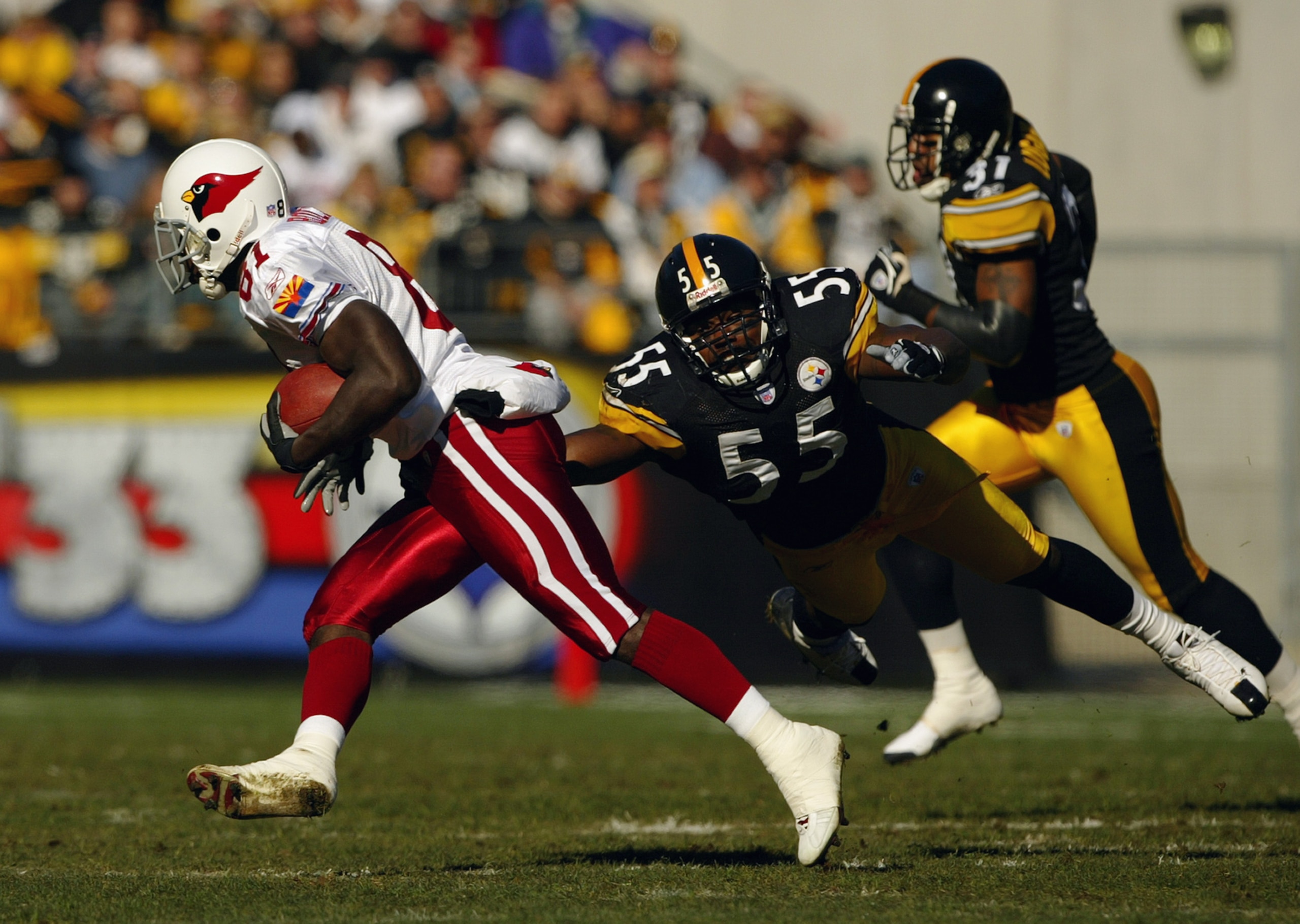 PITTSBURGH - NOVEMBER 9: Linebacker Joey Porter #55 of the Pittsburgh Steelers attempts to tackle wide receiver Anquan Boldin #81 during the game against the Arizona Cardinals on November 9, 2003 at Heinz Field in Pittsburgh, Pennsylvania. The Steelers d PITTSBURGH - NOVEMBER 9: Linebacker Joey Porter #55 of the Pittsburgh Steelers attempts to tackle wide receiver Anquan Boldin #81 during the game against the Arizona Cardinals on November 9, 2003 at Heinz Field in Pittsburgh, Pennsylvania. The Steelers d