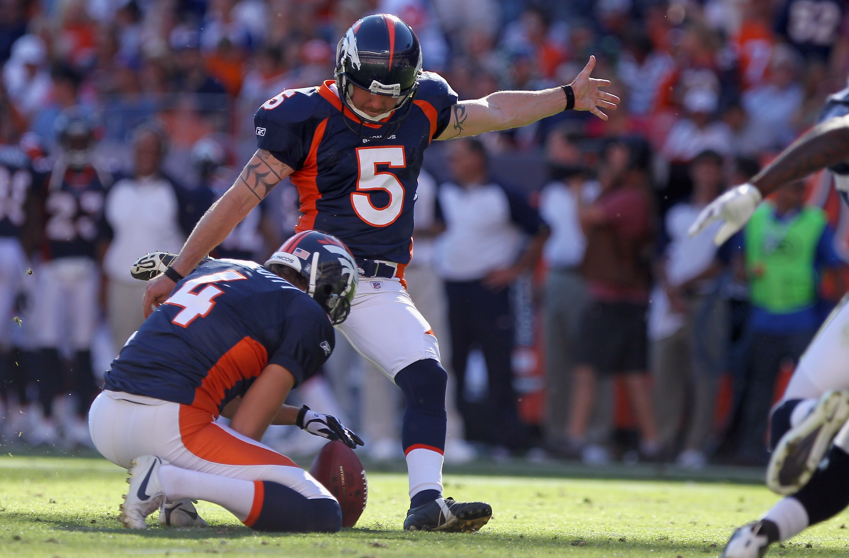 DENVER - SEPTEMBER 19:  Place kicker Matt Prater #5 of the Denver Broncos attempts a field goal from the hold of Britton Colquitt #4 against the Seattle Seahawks at INVESCO Field at Mile High on September 19, 2010 in Denver, Colorado. The Broncos defeated
