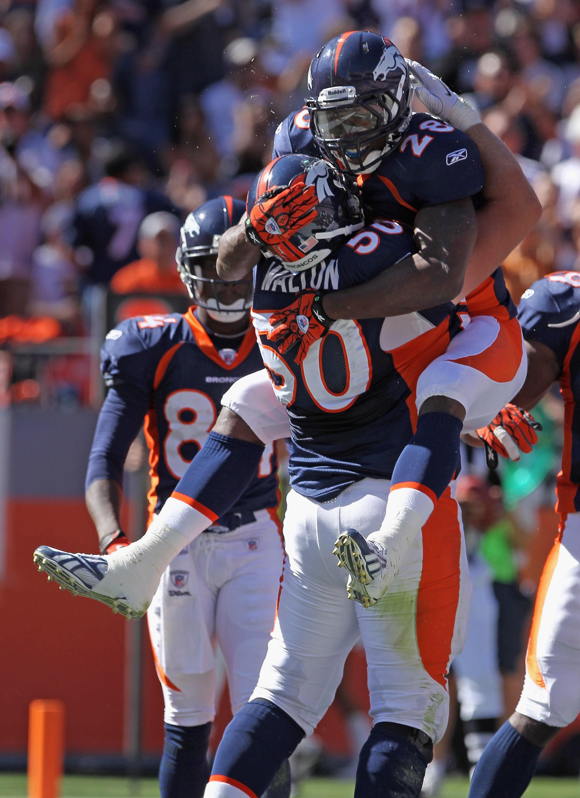 DENVER - SEPTEMBER 19:  Running back Correll Buckhalter #28 of the Denver Broncos celebrates his one yard touchdown with center J.D. Walton #50 in the second quarter against the Seattle Seahawks at INVESCO Field at Mile High on September 19, 2010 in Denve