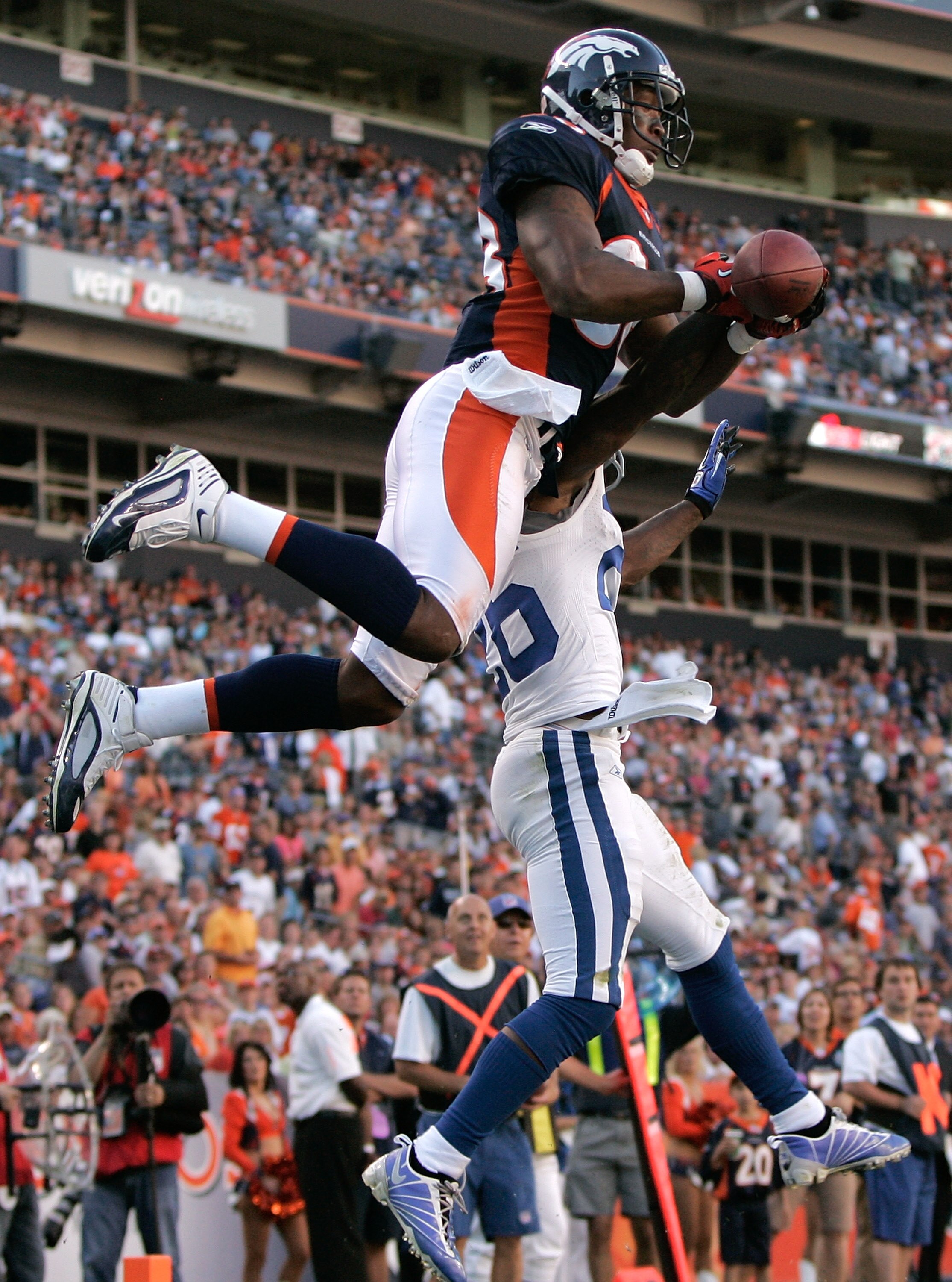 DENVER - SEPTEMBER 26:  Wide receiver Demaryius Thomas #88 of the Denver Broncos battles in the air with cornerback Kelvin Hayden #26 of the Indianapolis Colts during NFL action at INVESCO Field at Mile High on September 26, 2010 in Denver, Colorado. The 