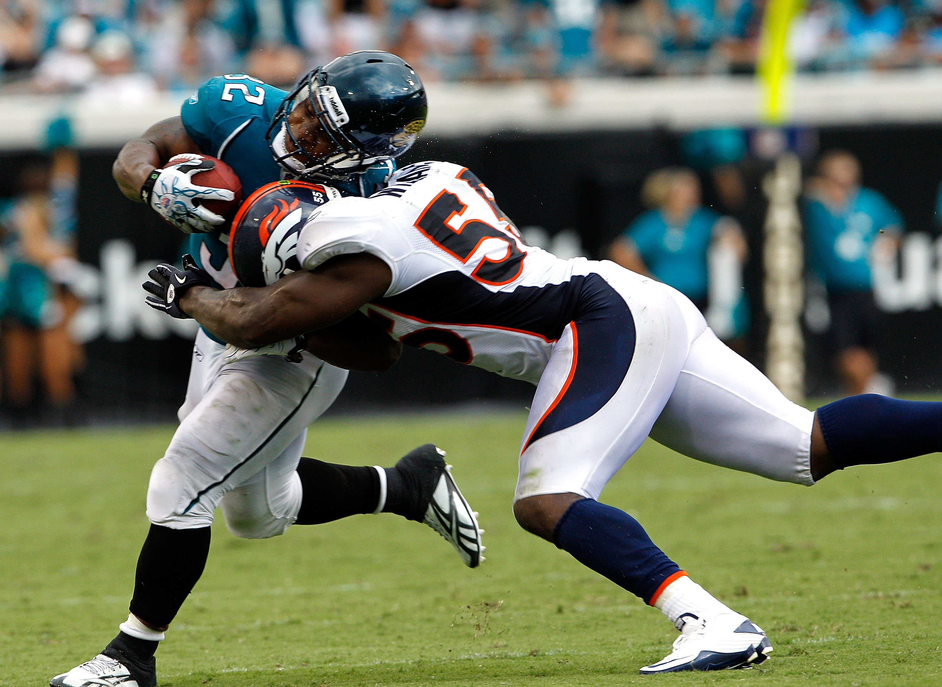JACKSONVILLE, FL - SEPTEMBER 12:  D.J. Williams #55 of the Denver Broncos attempts to tackle Maurice Jones-Drew #32 of the Jacksonville Jaguars during the NFL season opener game at EverBank Field on September 12, 2010 in Jacksonville, Florida.  (Photo by 