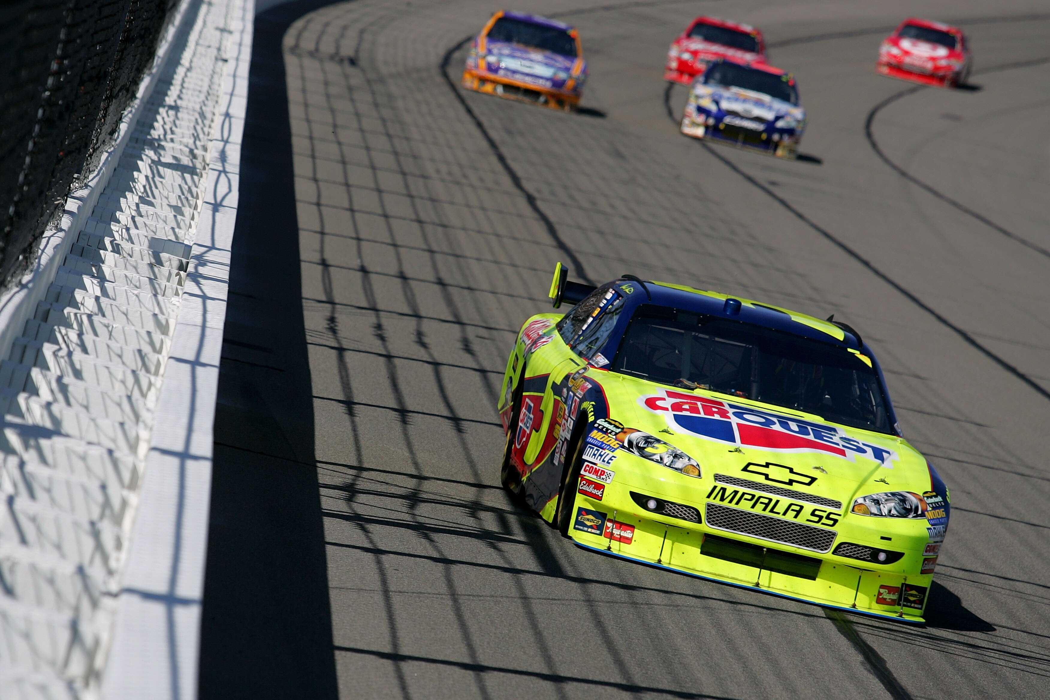 KANSAS CITY, KS - OCTOBER 04:  Mark Martin, driver of the #5 CARQUEST / Kellogg's Chevrolet, leads a pack of cars during the NASCAR Sprint Cup Series Price Chopper 400 presented by Kraft Foods at the Kansas Speedway on October 4, 2009 in Kansas City, Kans