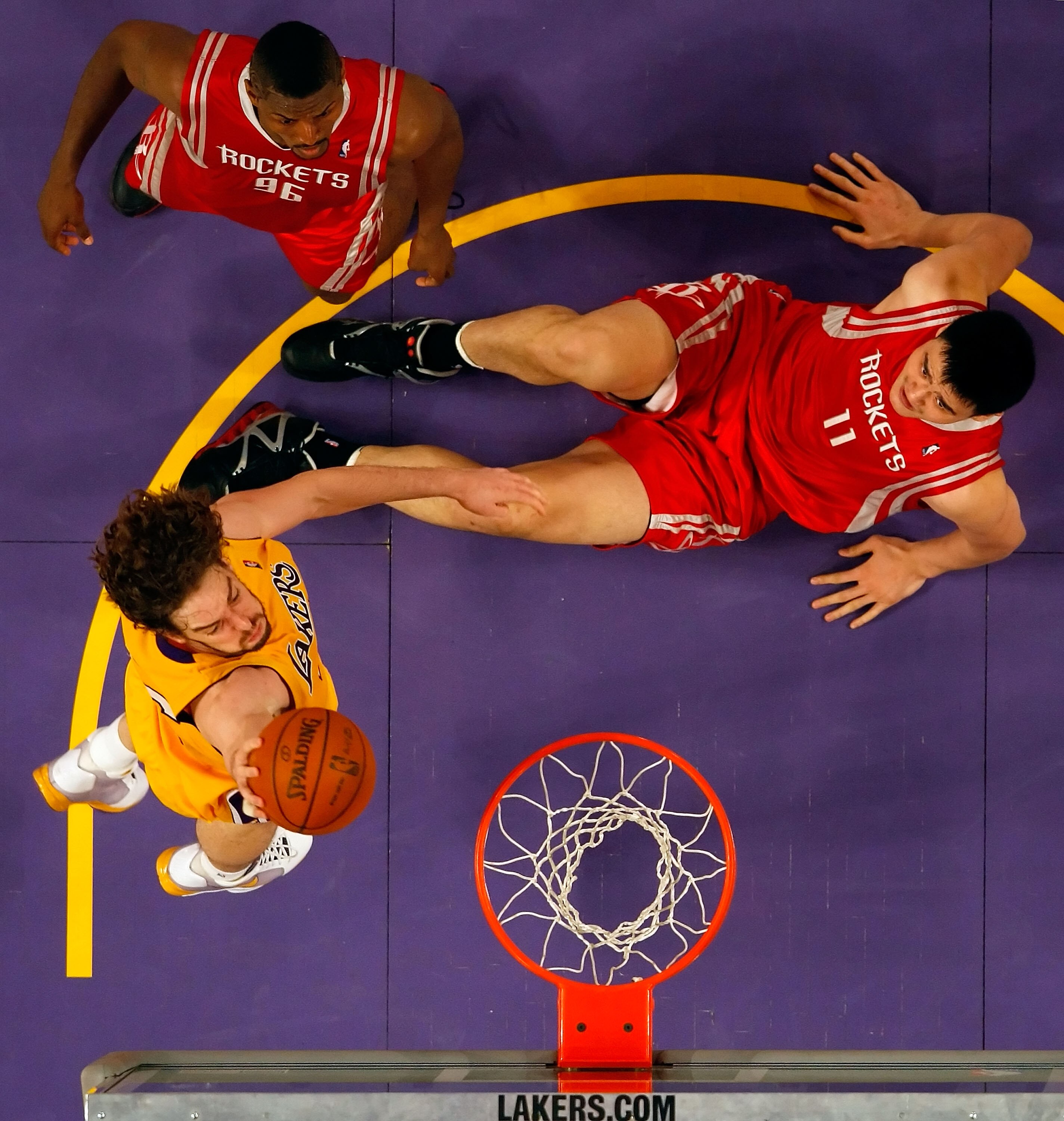 LOS ANGELES, CA - MAY 04:  Pau Gasol #16 of the Los Angeles Lakers goes up for a shot as Yao Ming #11 and Ron Artest #96 of the Houston Rockets look on in Game One of the Western Conference Semifinals during the 2009 NBA Playoffs at Staples Center on May