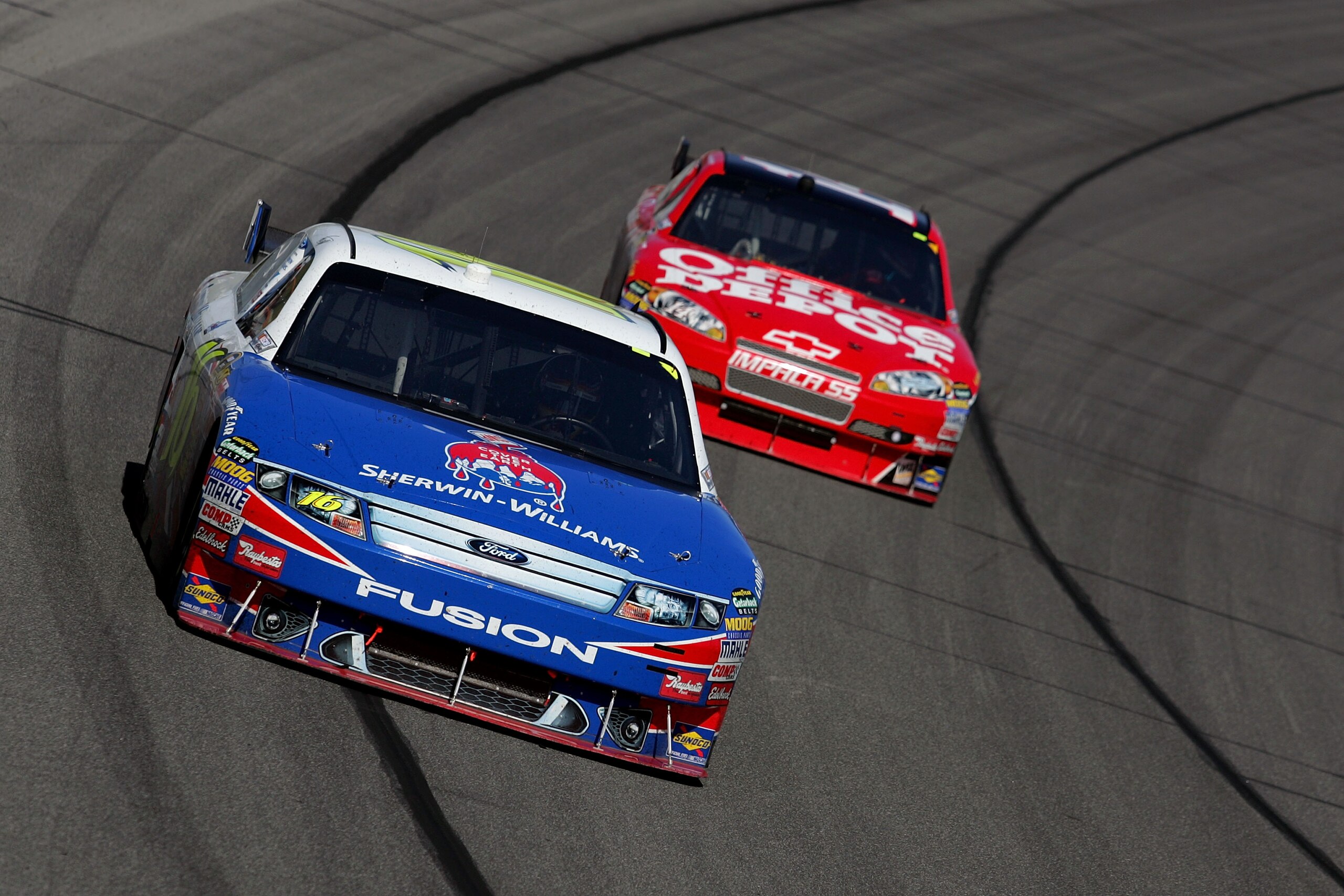 KANSAS CITY, KS - OCTOBER 04:  Greg Biffle, driver of the #M / Sherwin Williams Ford, leads Tony Stewart, driver of the #14 Office Depot / Old Spice Chevrolet, during the NASCAR Sprint Cup Series Price Chopper 400 presented by Kraft Foods at the Kansas Sp