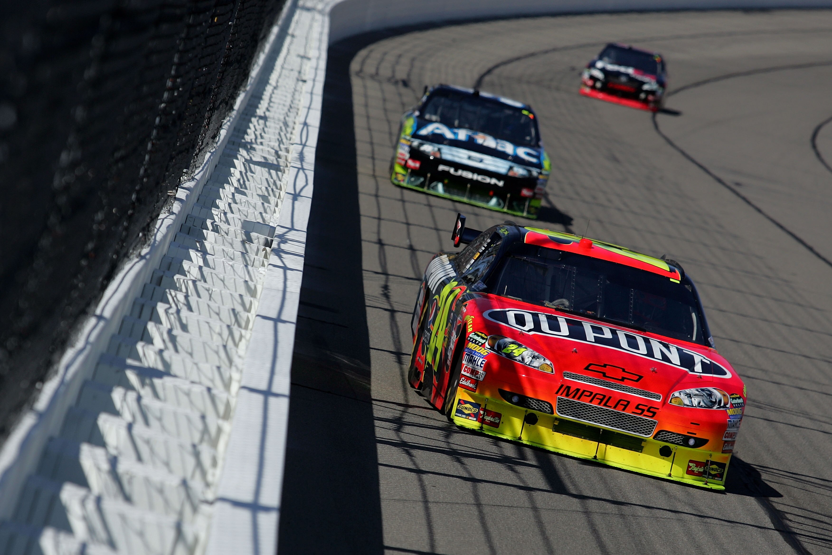 KANSAS CITY, KS - OCTOBER 04:  Jeff Gordon, driver of the #24 DuPont Chevrolet, leads Carl Edwards, driver of the #99 Aflac Ford during the NASCAR Sprint Cup Series Price Chopper 400 presented by Kraft Foods at the Kansas Speedway on October 4, 2009 in Ka
