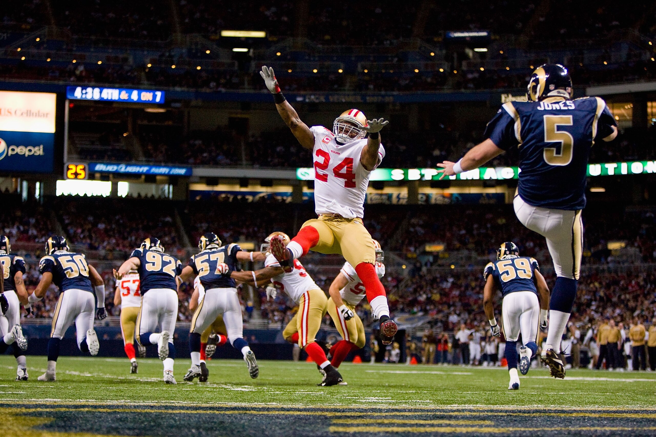 ST. LOUIS - JANUARY 3: Michael Robinson #24 of the San Francisco 49ers leaps to block the punt by Donnie Jones #5 of the St. Louis Rams at the Edward Jones Dome on January 3, 2010 in St. Louis, Missouri.  The 49ers beat the Rams 28-6.  (Photo by Dilip Vis