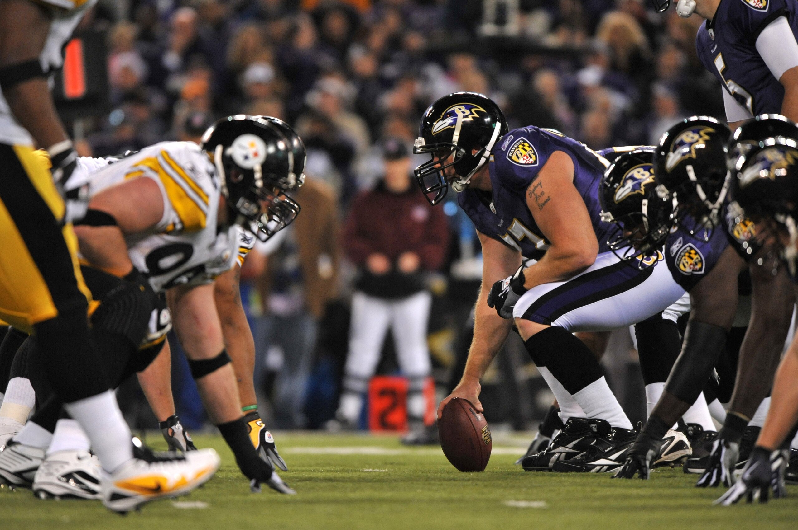 BALTIMORE - NOVEMBER 29:  Matt Birk #77 of the Baltimore Ravens snaps the ball during the game against the Pittsburgh Steelers at M&T Bank Stadium on November 29, 2009 in Baltimore, Maryland. The Ravens defeated the Steelers 20-17. (Photo by Larry French/