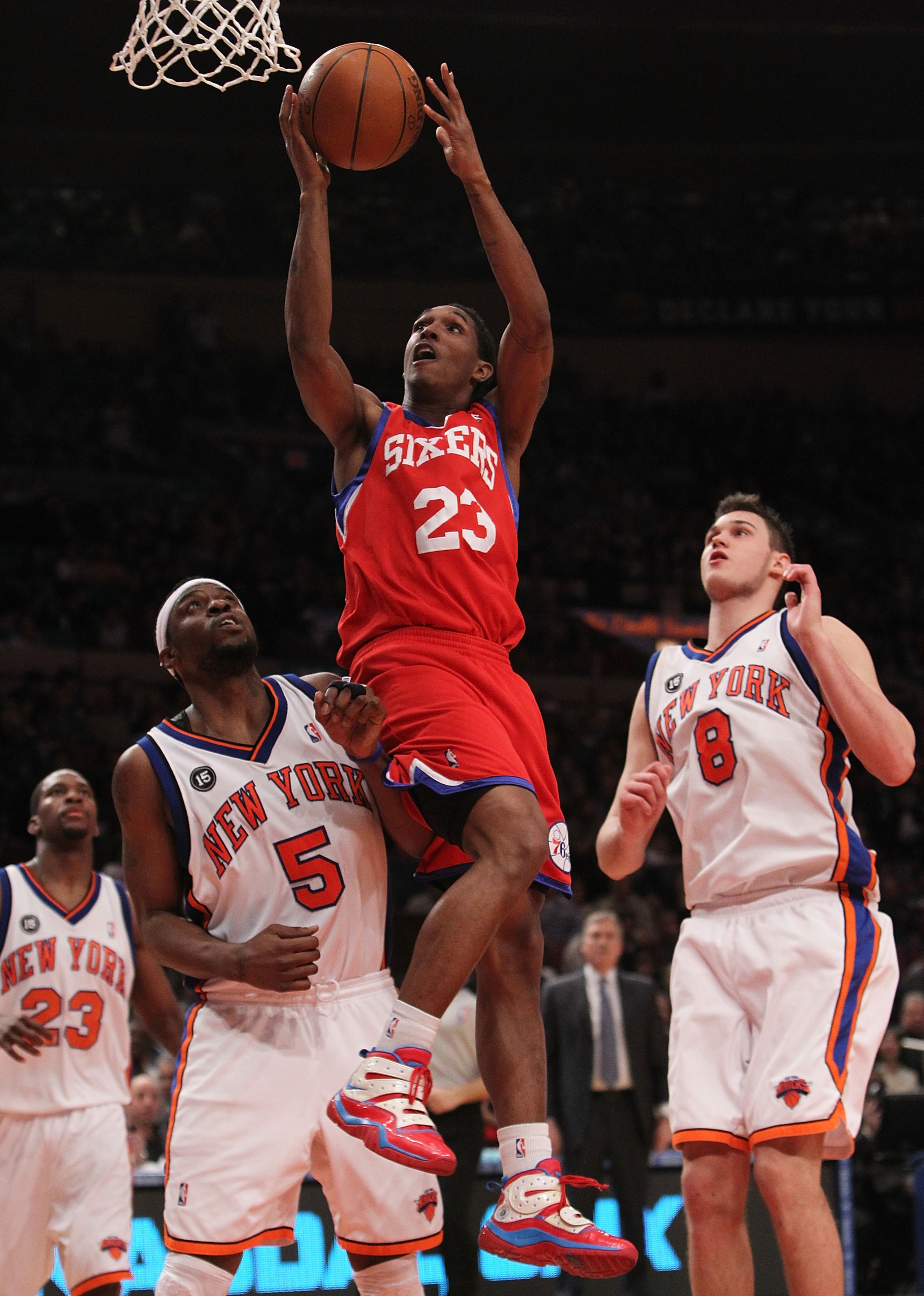 NEW YORK - MARCH 19:  Louis Williams #23 of the Philadelphia 76ers lays the ball up in between Bill Walker #5 and Danilo Gallinari #8 of the New York Knicks at Madison Square Garden on March 19, 2010 in New York City. NOTE TO USER: User expressly acknowle