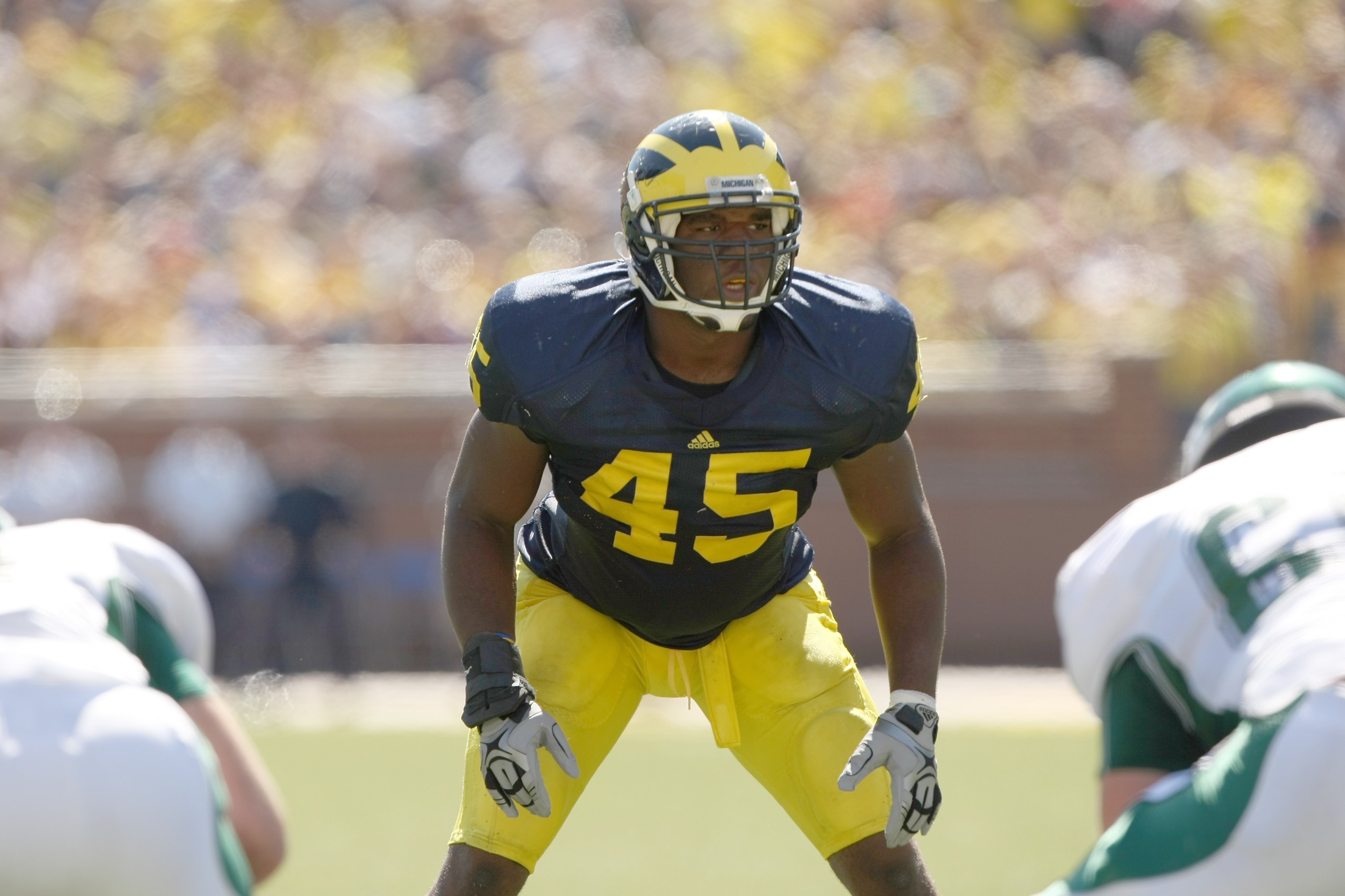 ANN ARBOR, MI - SEPTEMBER 19:  Middle linebacker Obi Ezeh #45 of the Michigan Wolverinesets for a play against the Eastern Michigan Eagles at Michigan Stadium on September 19, 2009 in Ann Arbor, Michigan.  Michigan won 45-17.  (Photo by Stephen Dunn/Getty