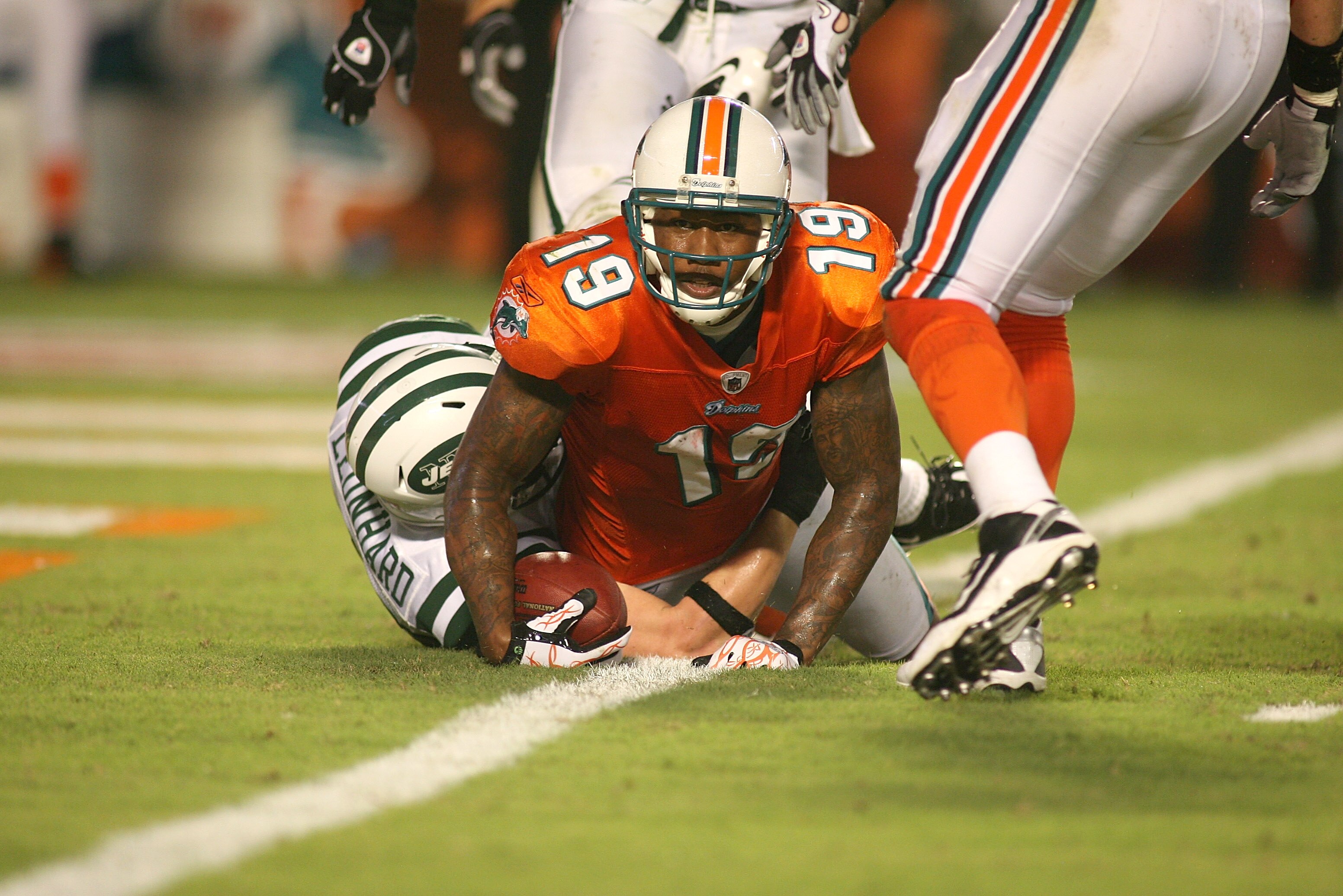 MIAMI - SEPTEMBER 26: Receiver Brandon Marshall #19 of the Miami Dolphins scores a touchdown against the New York Jets at Sun Life Stadium on September 26, 2010 in Miami, Florida. The Jets won 31-23. (Photo by Marc Serota/Getty Images)